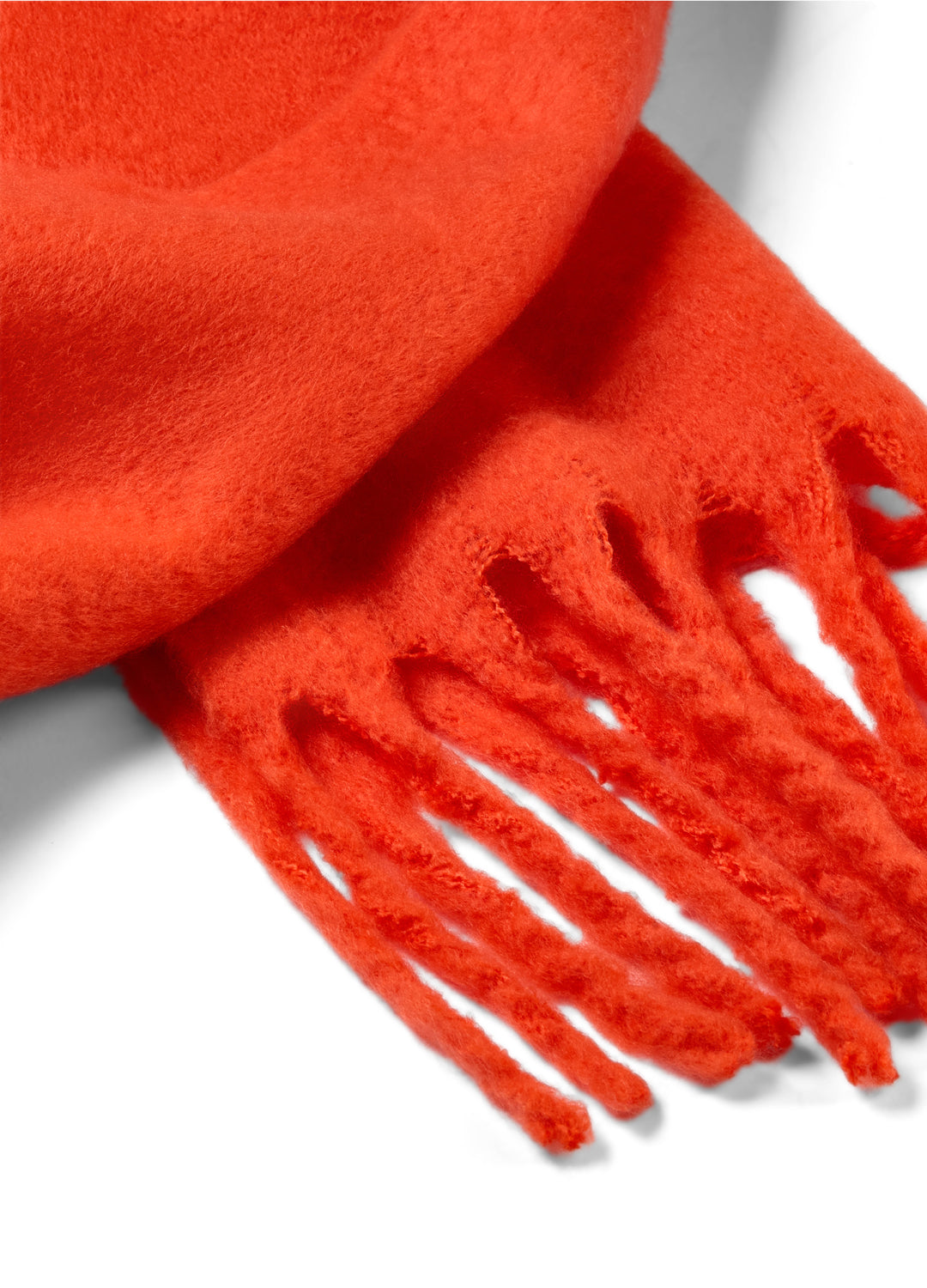 Close-up of a bright fiery orange scarf with fringes on a white background