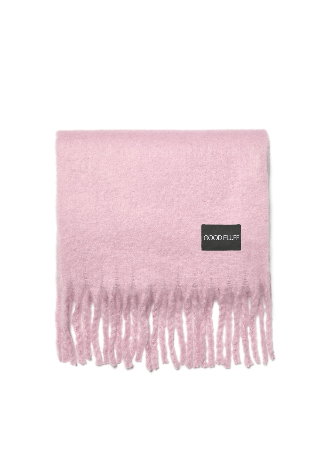Pink blanket with fringes and a visible brand label on a white background