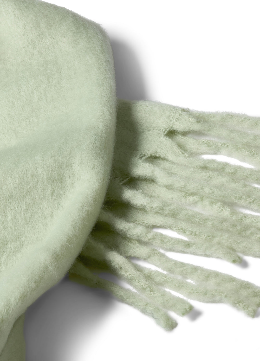 Light green scarf with fringes on a white background
