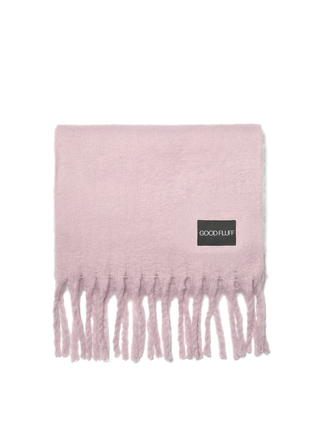 Pink blanket with fringes and a visible brand label on a white background