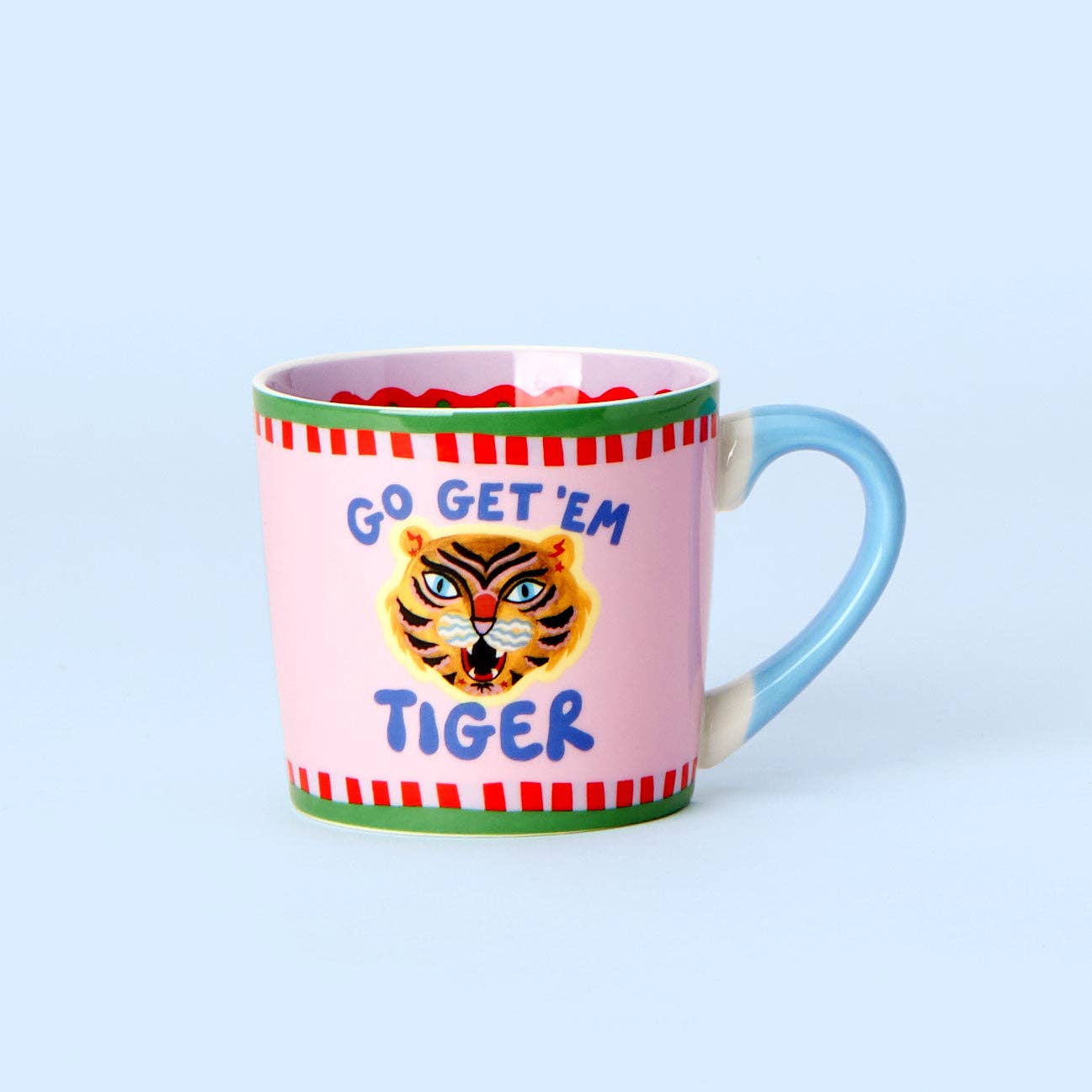Pink mug with tiger design and 'Go Get 'Em Tiger' text on a light blue background