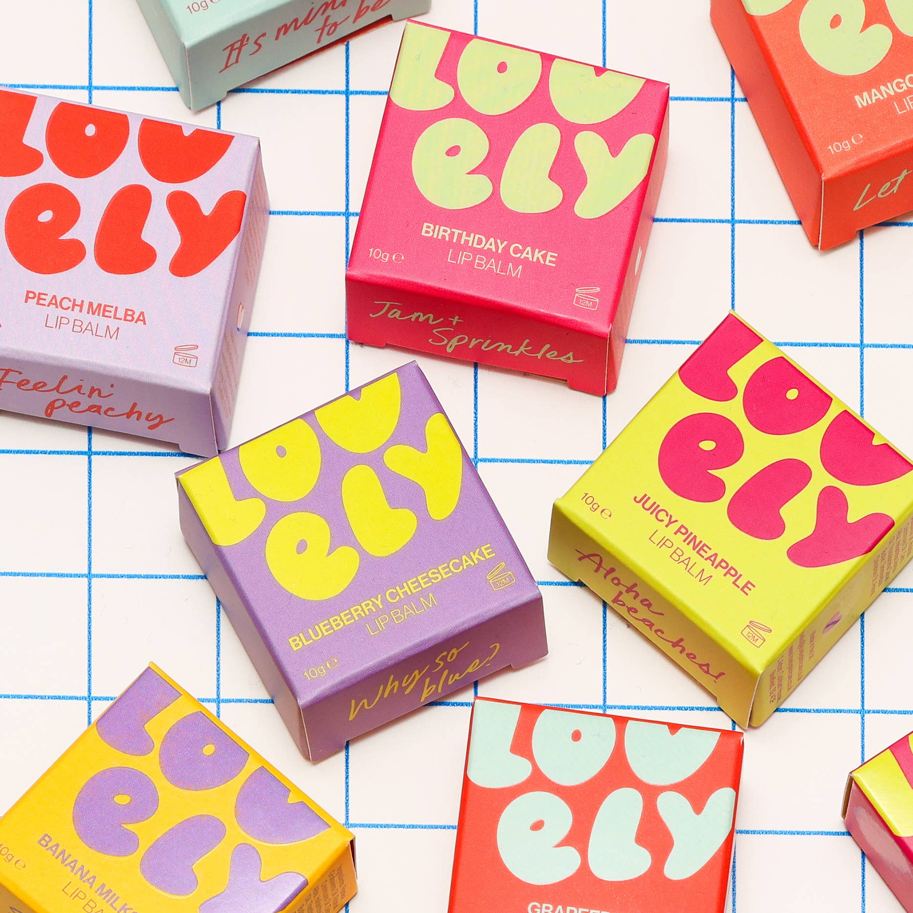 Colorful 'Lovely' lip balm boxes on a grid background