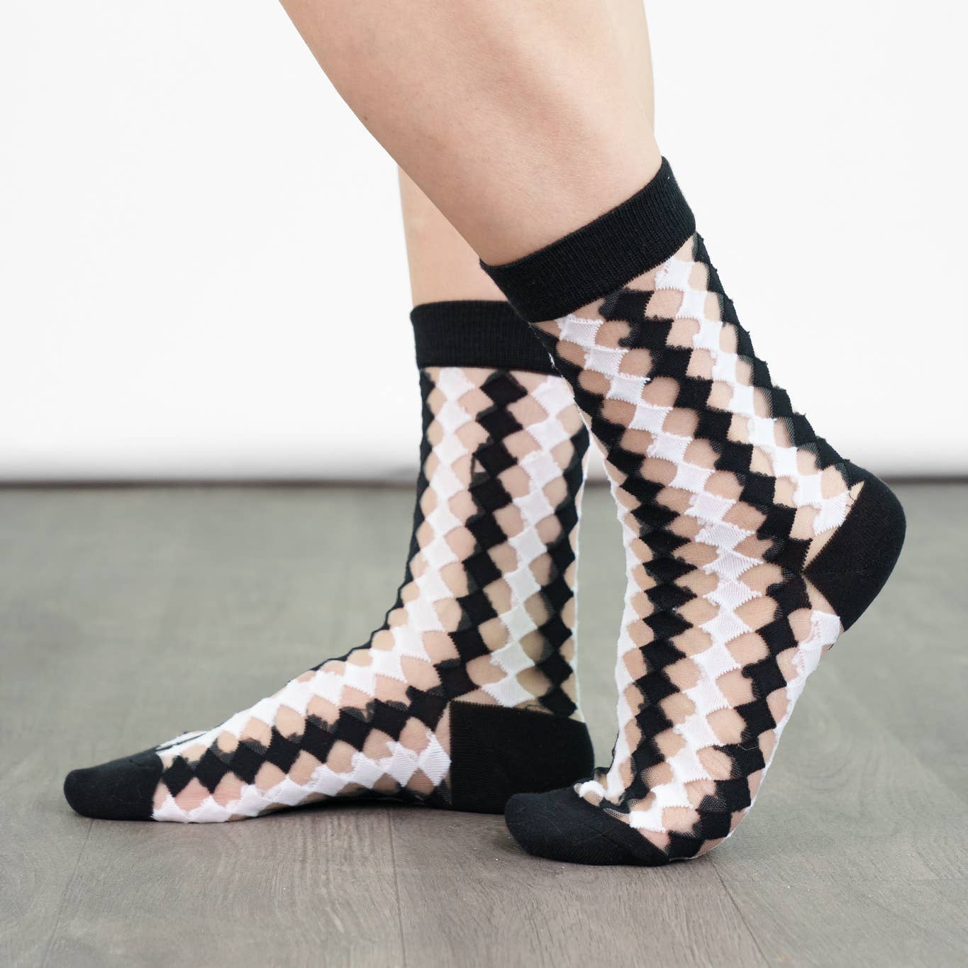 Patterned socks worn on a neutral background
