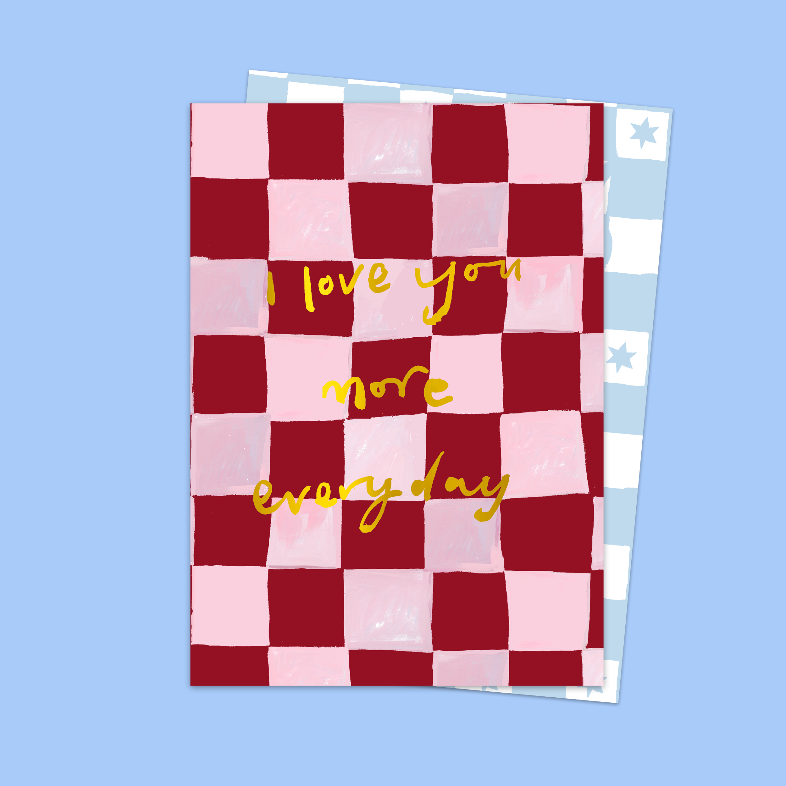 Checkered card with 'I love you more every day' text on a blue background