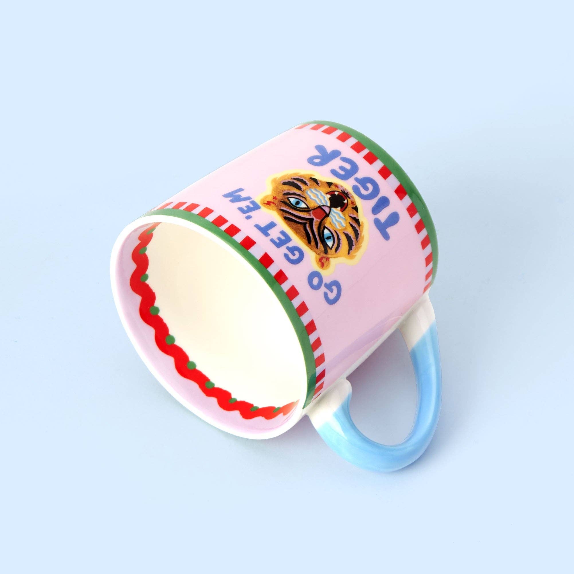 Colorful mug with a cartoon tiger design on a light blue background