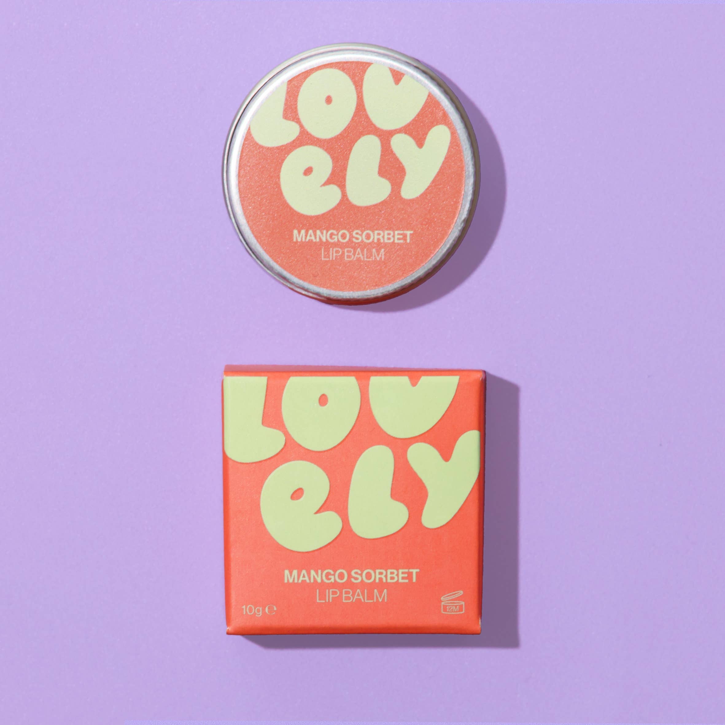 Lovely Mango Sorbet lip balm with packaging on a purple background