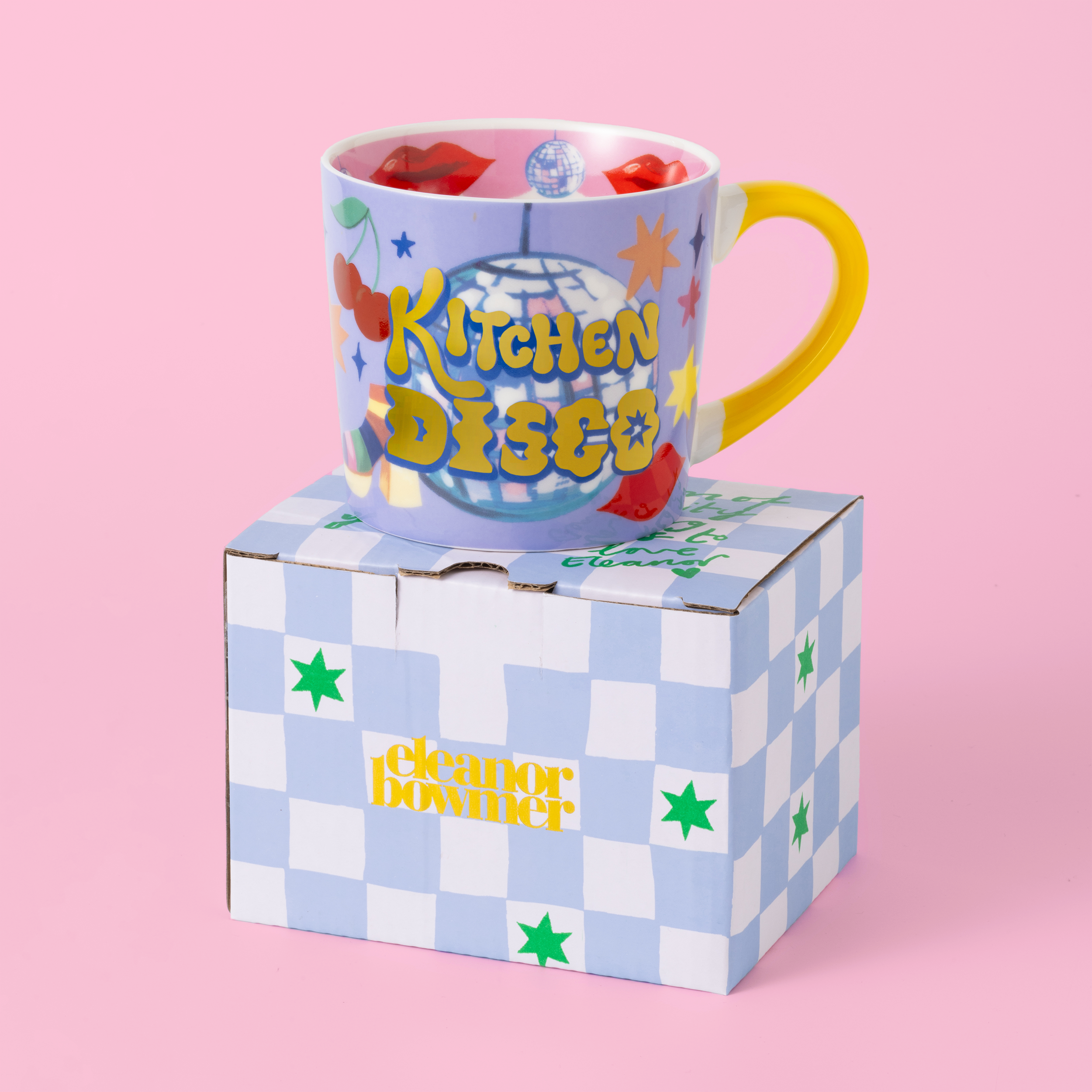 Colorful mug with 'Kitchen Disco' text on a checkered box against a pink background