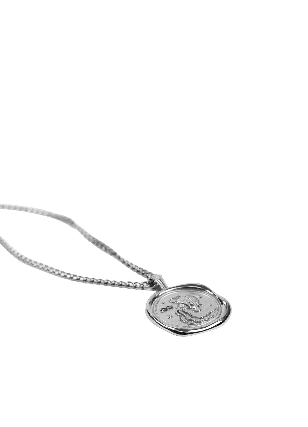 A silver chain necklace with a round, textured silver pendant featuring an anchor design, shown against a plain white background.