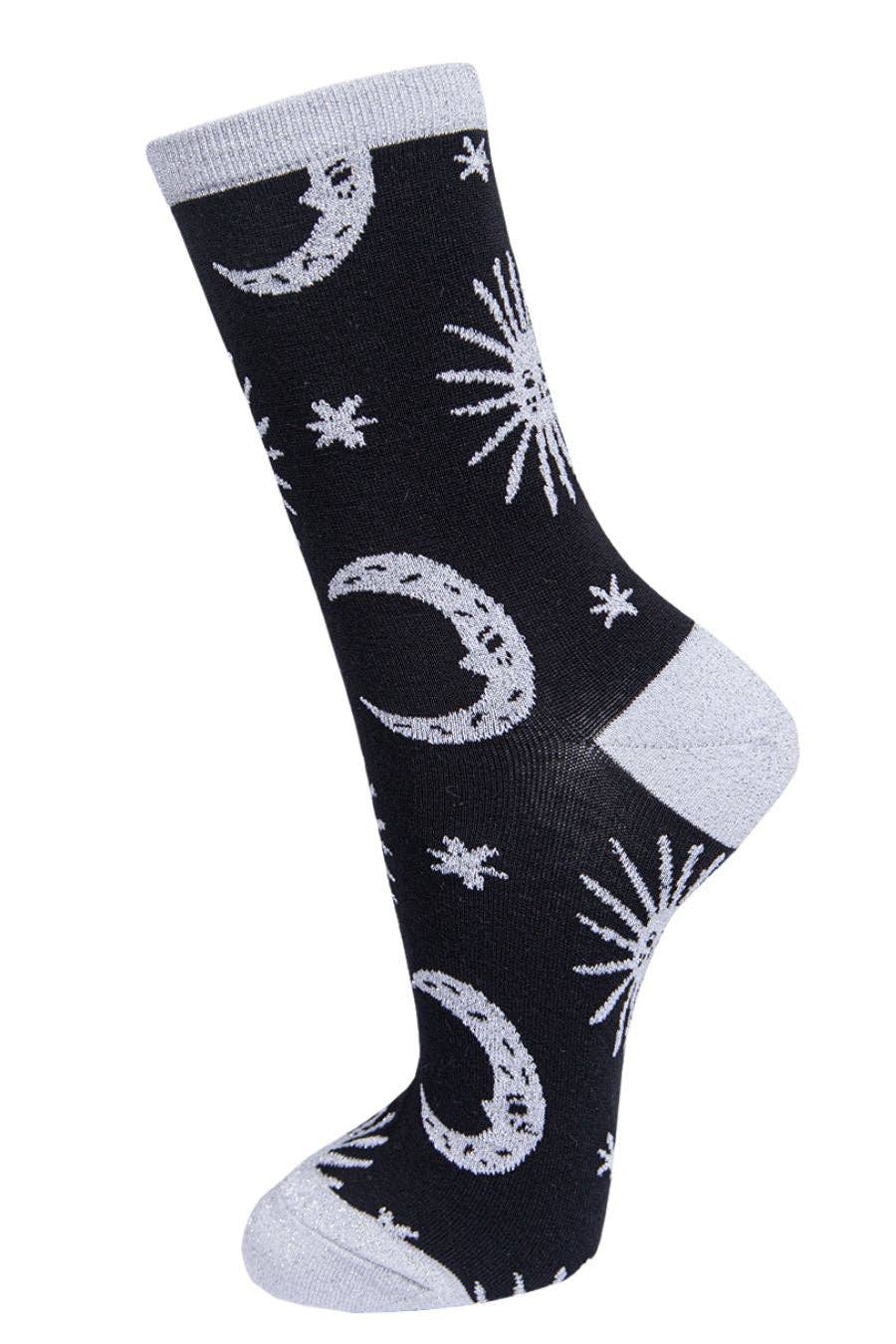 Black sock with white moon and star patterns on a white background