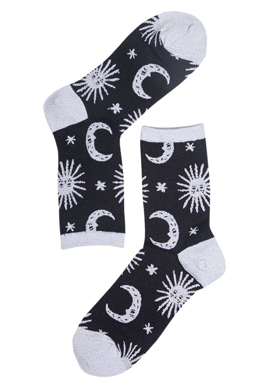 Black socks with white moon, star, and sun patterns on a white background