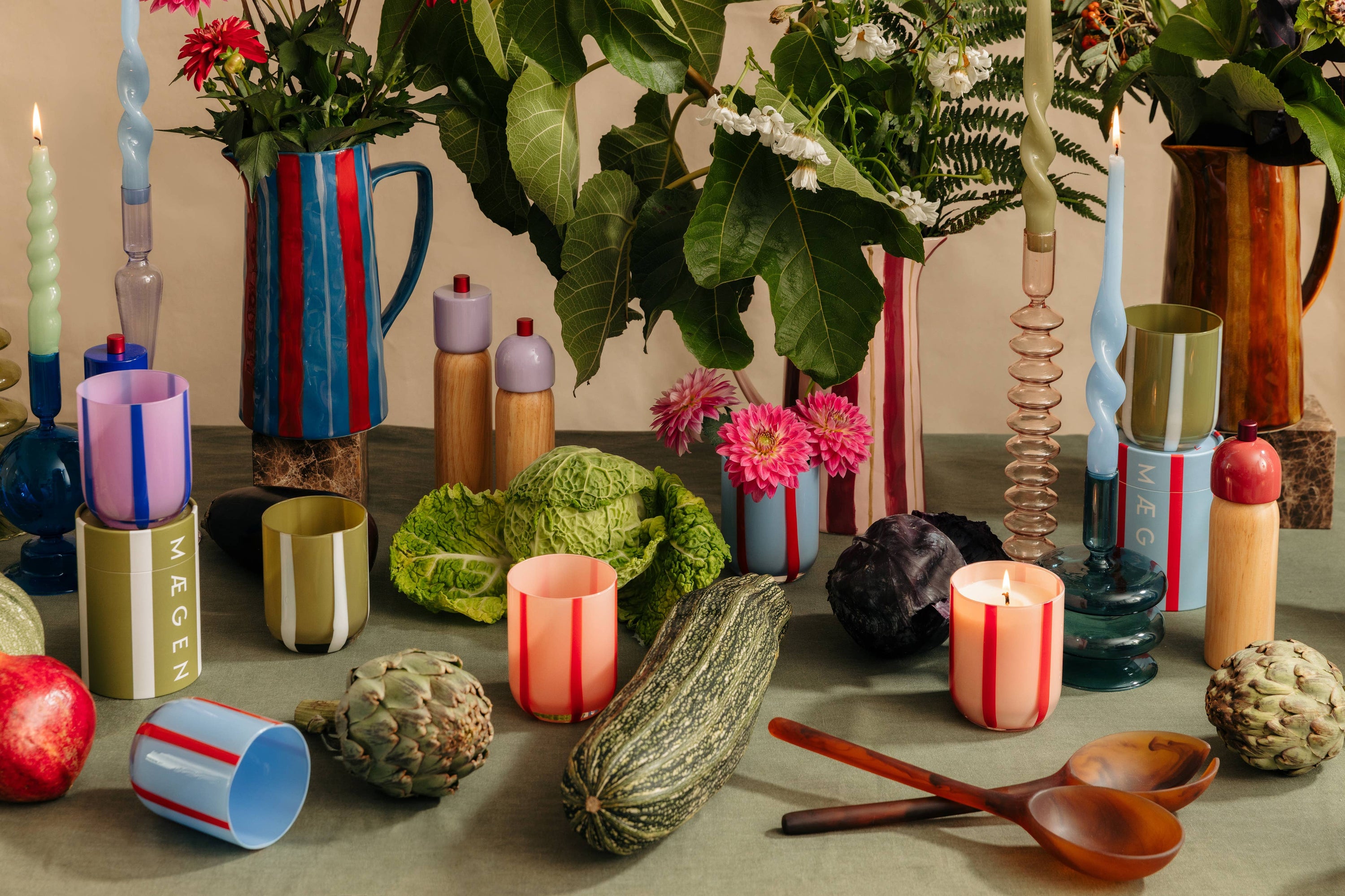A VARIETY OF MAEGEN PRODUCTS IN A TABLE SETTING WITH ROOT VEG