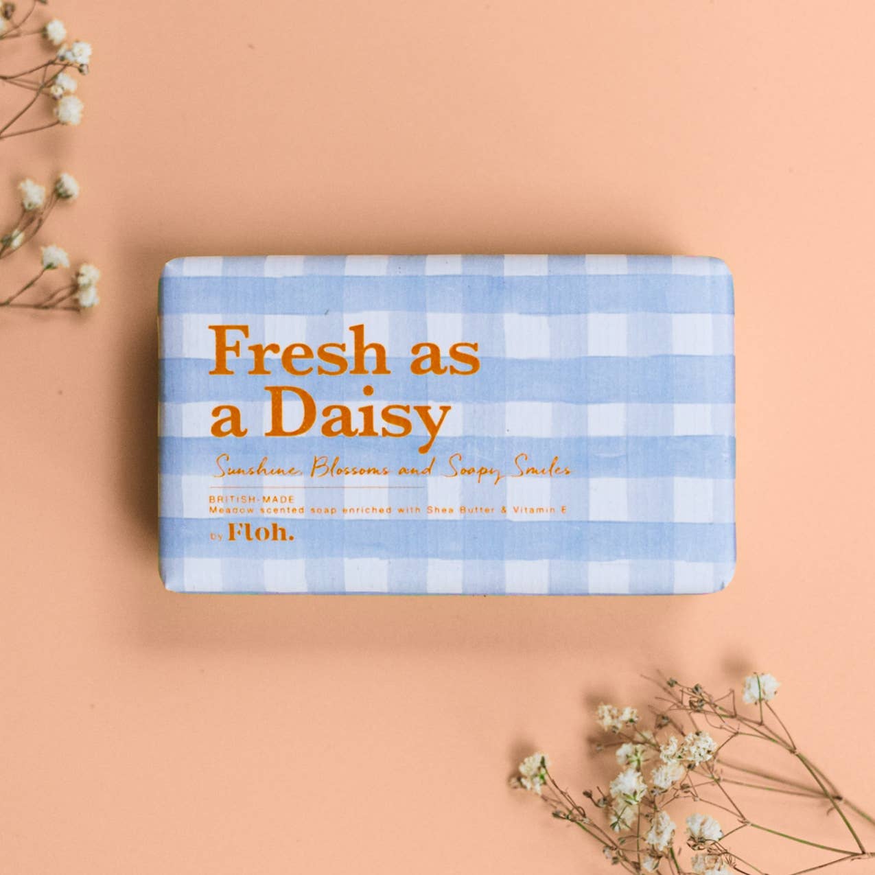 Bar of soap with 'Fresh as a Daisy' text on a checkered background