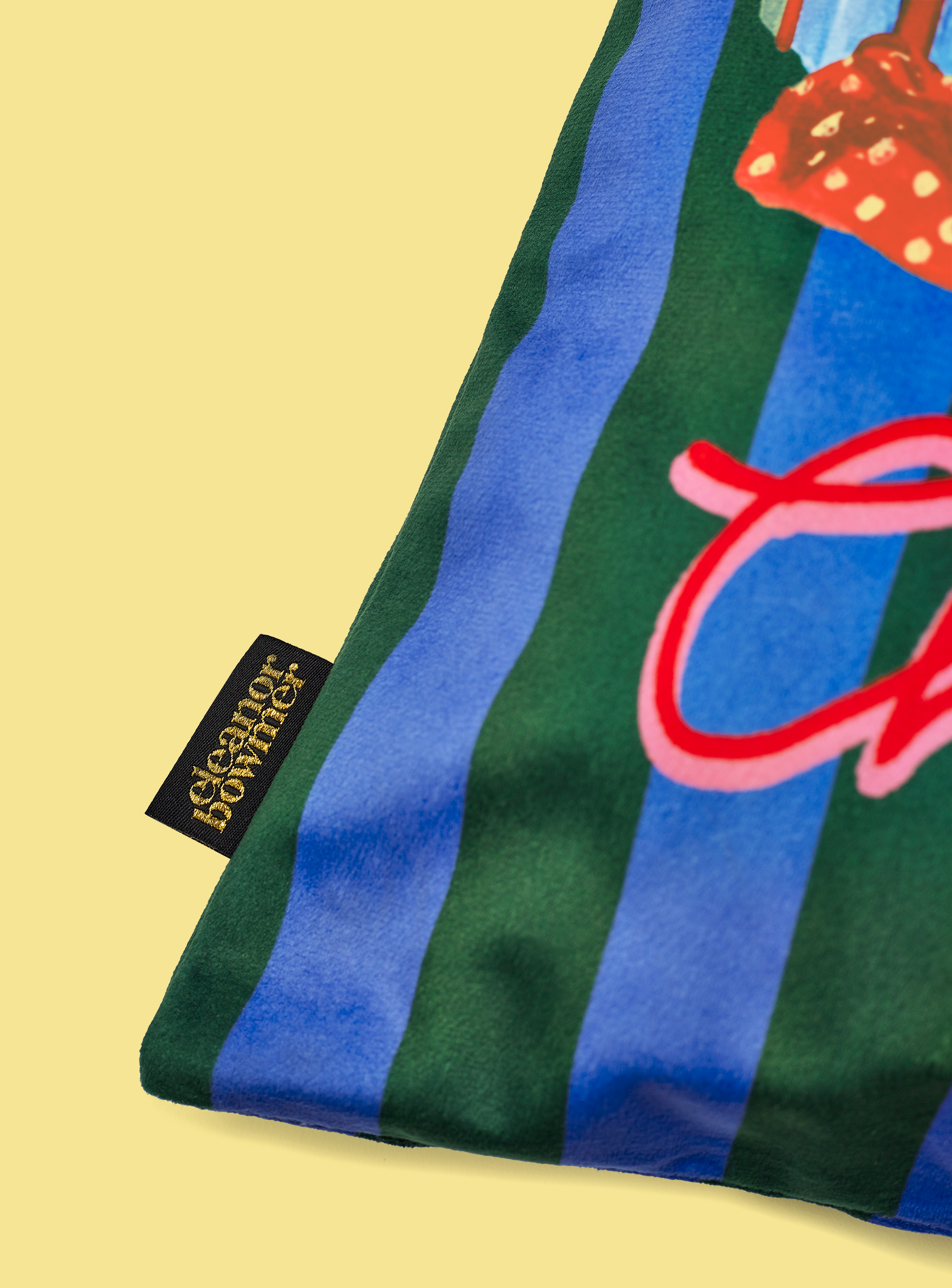 Striped Christmas sack with festive design and brand label on a yellow background