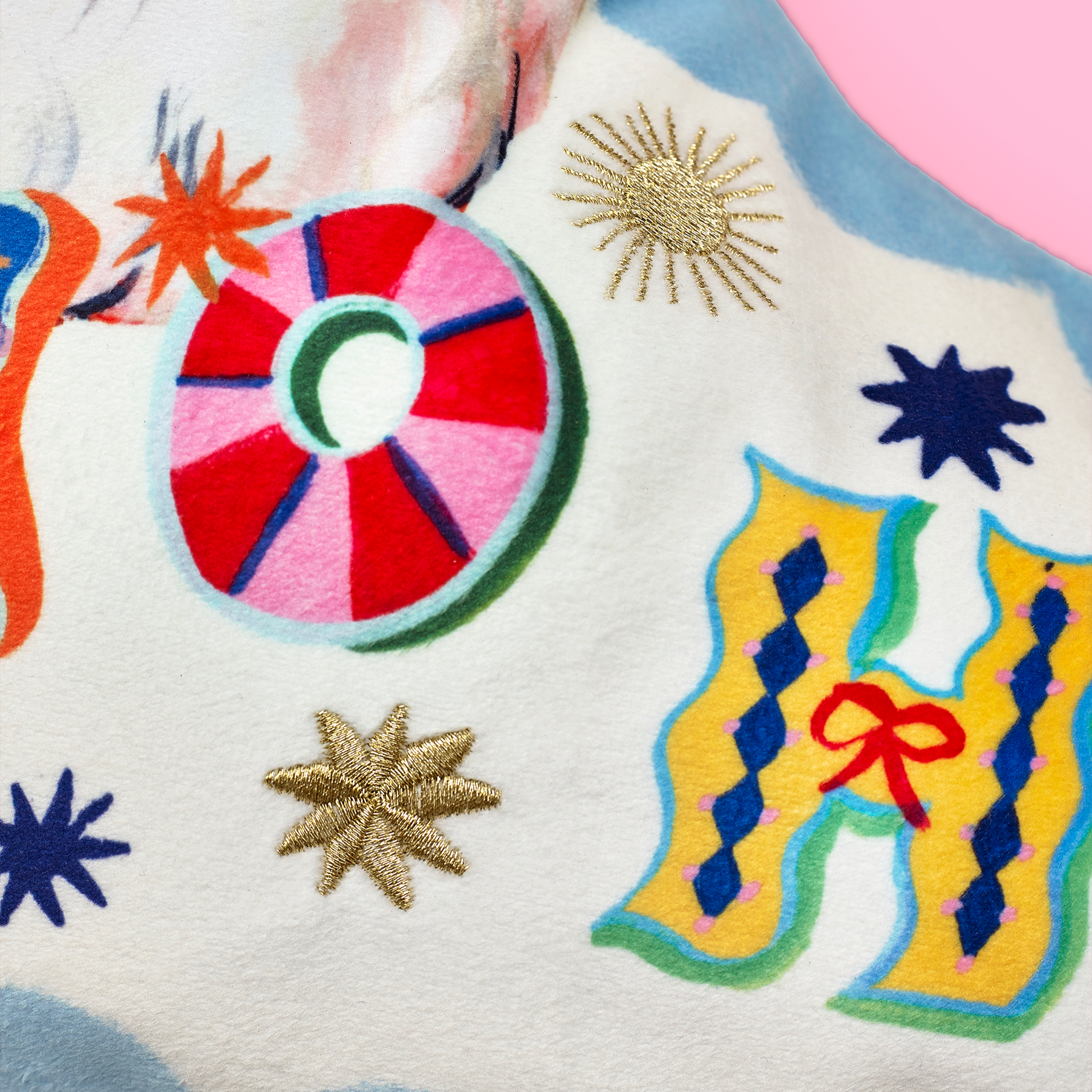 Colourful embroidered design on a fabric background