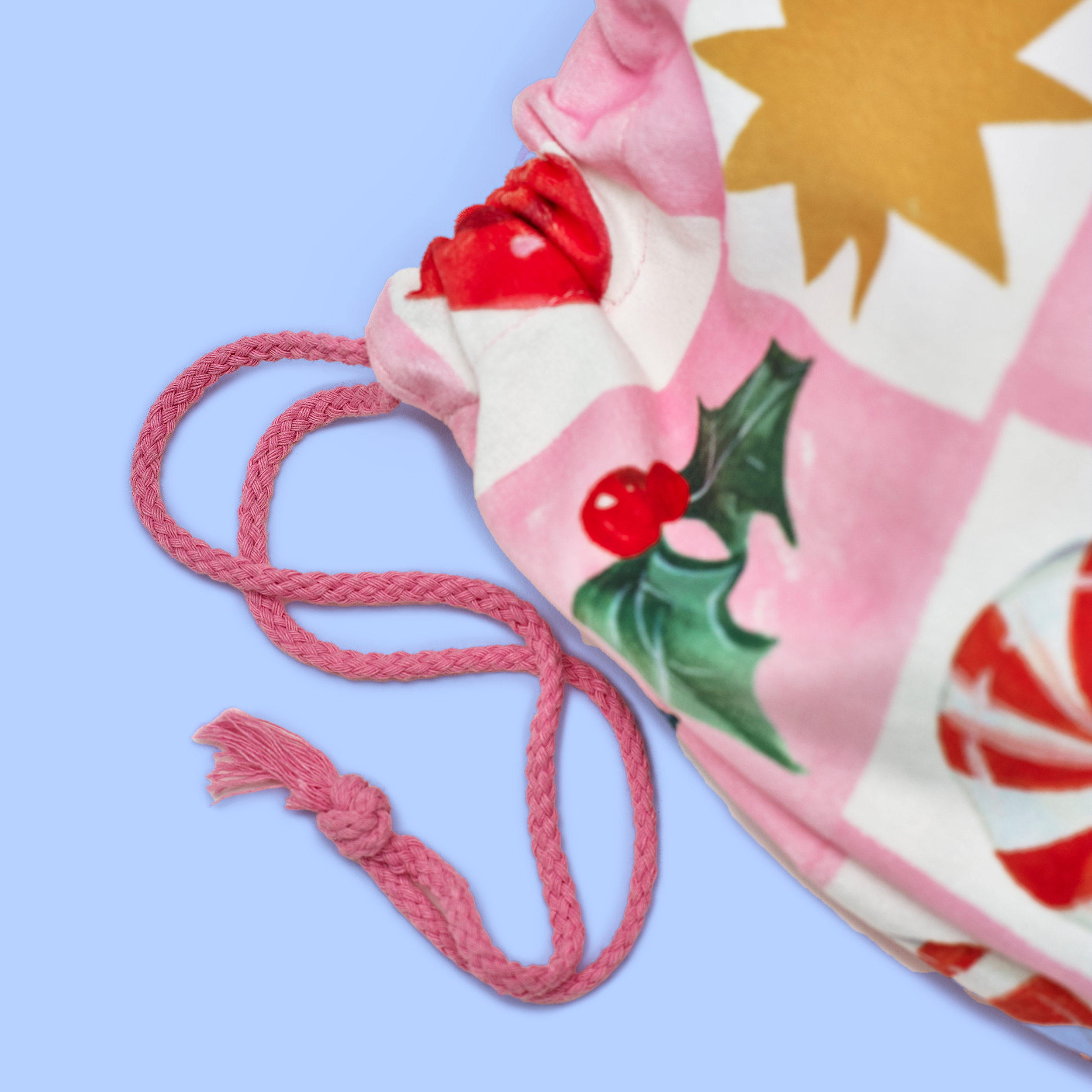 Drawstring bag with festive design on a light blue background
