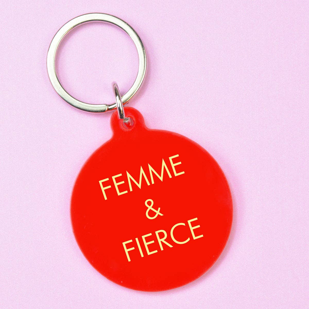 Red keychain with 'Femme & Fierce' text on a pink background