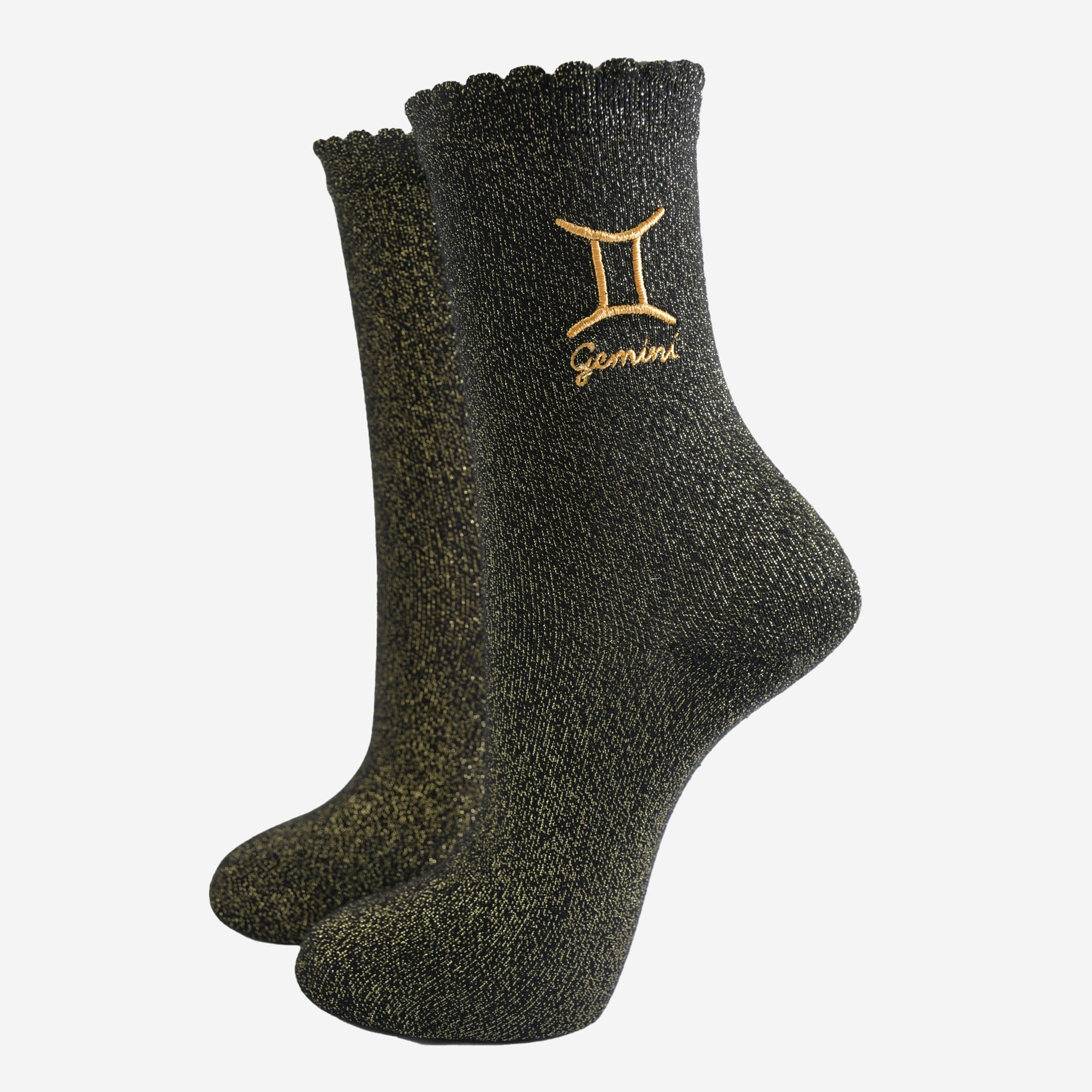 Black socks with 'Gemini' zodiac sign embroidery on a white background