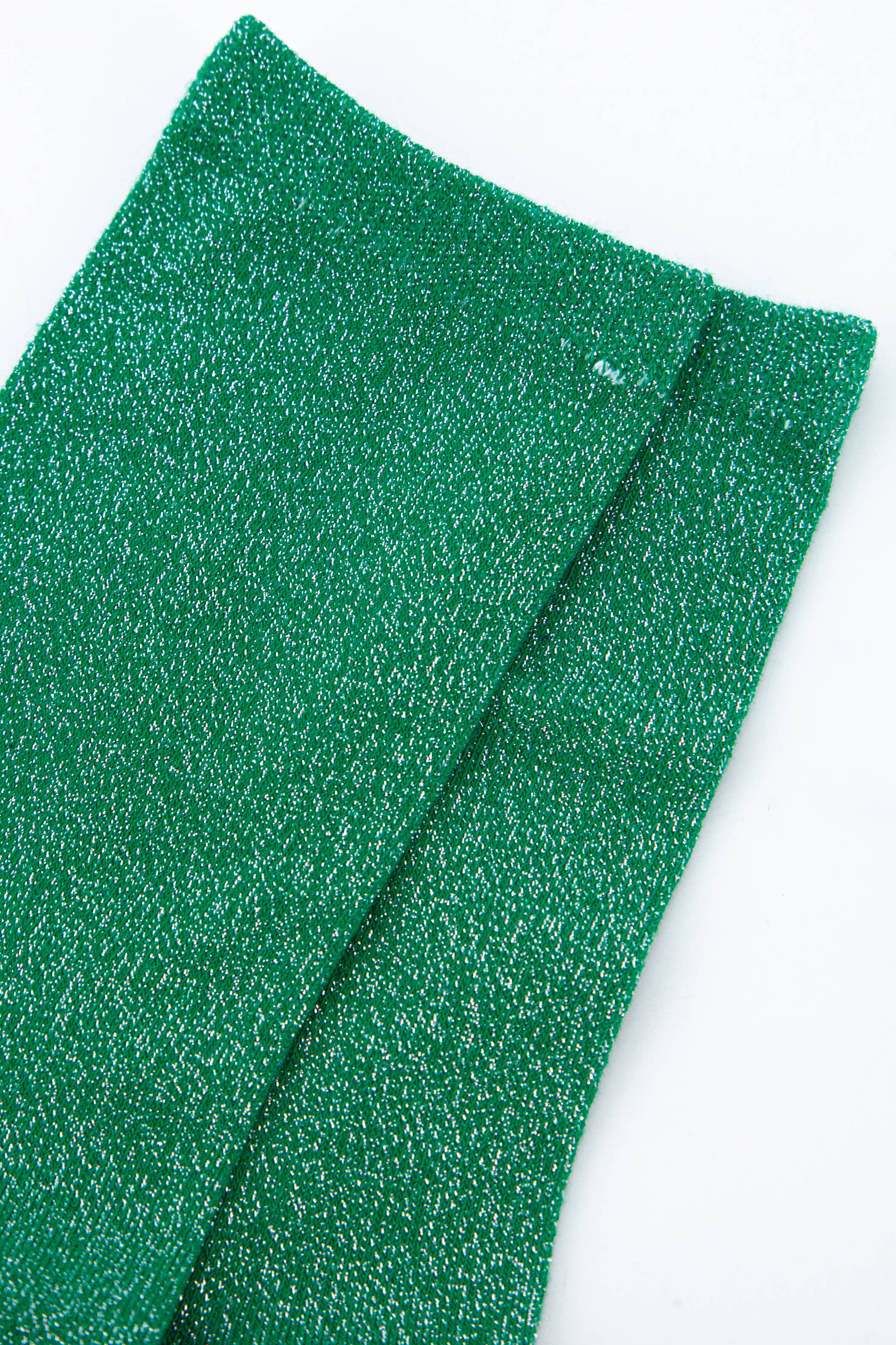 Two green glittery sheets on a white background