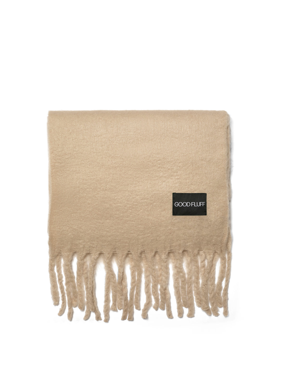 Creamy oat beige scarf with fringes and a black label on a white background