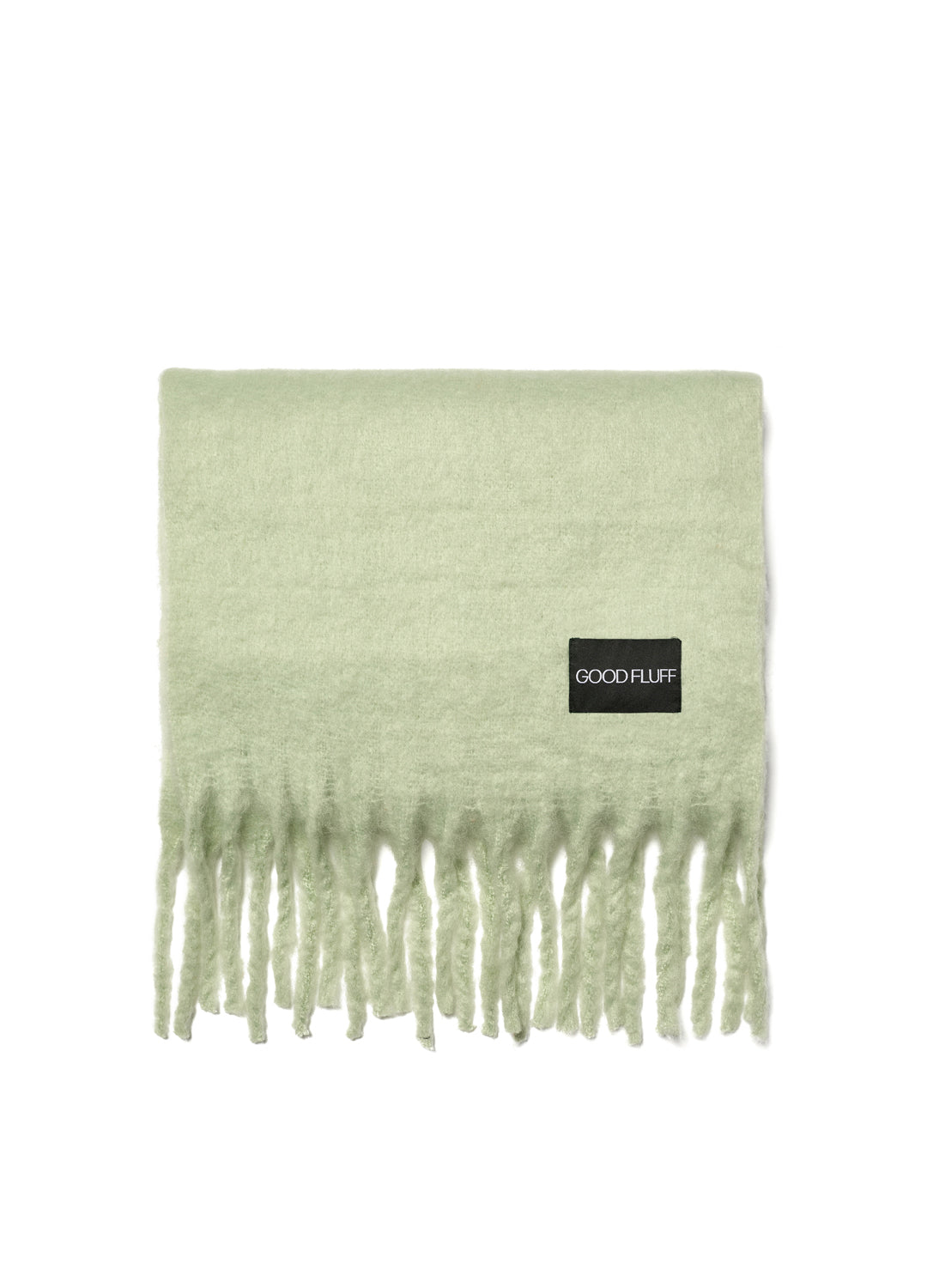 Pale water lily green scarf with fringe and 'GOOD FLUFF' label on a white background