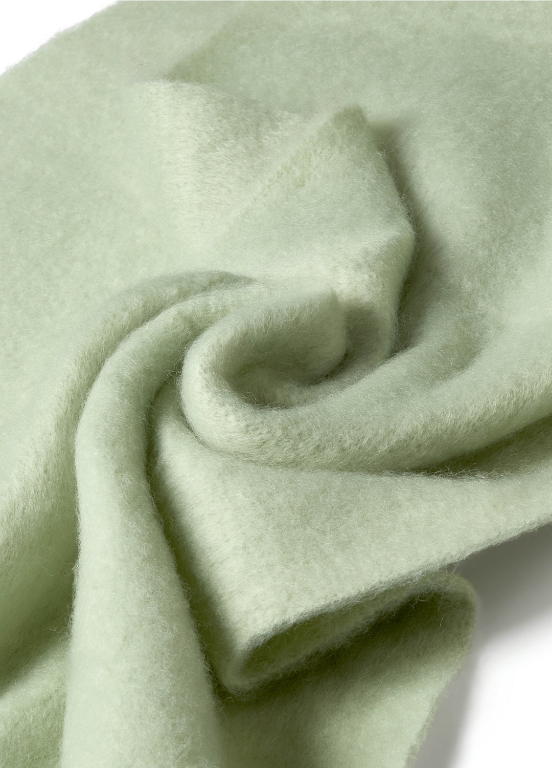 Close-up of a light green fabric with folds