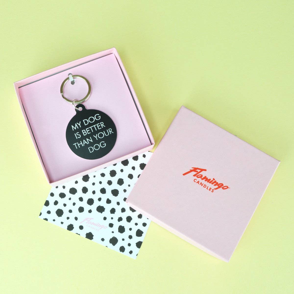 Keychain with 'My dog is better than your dog' text in a pink box on a light green background
