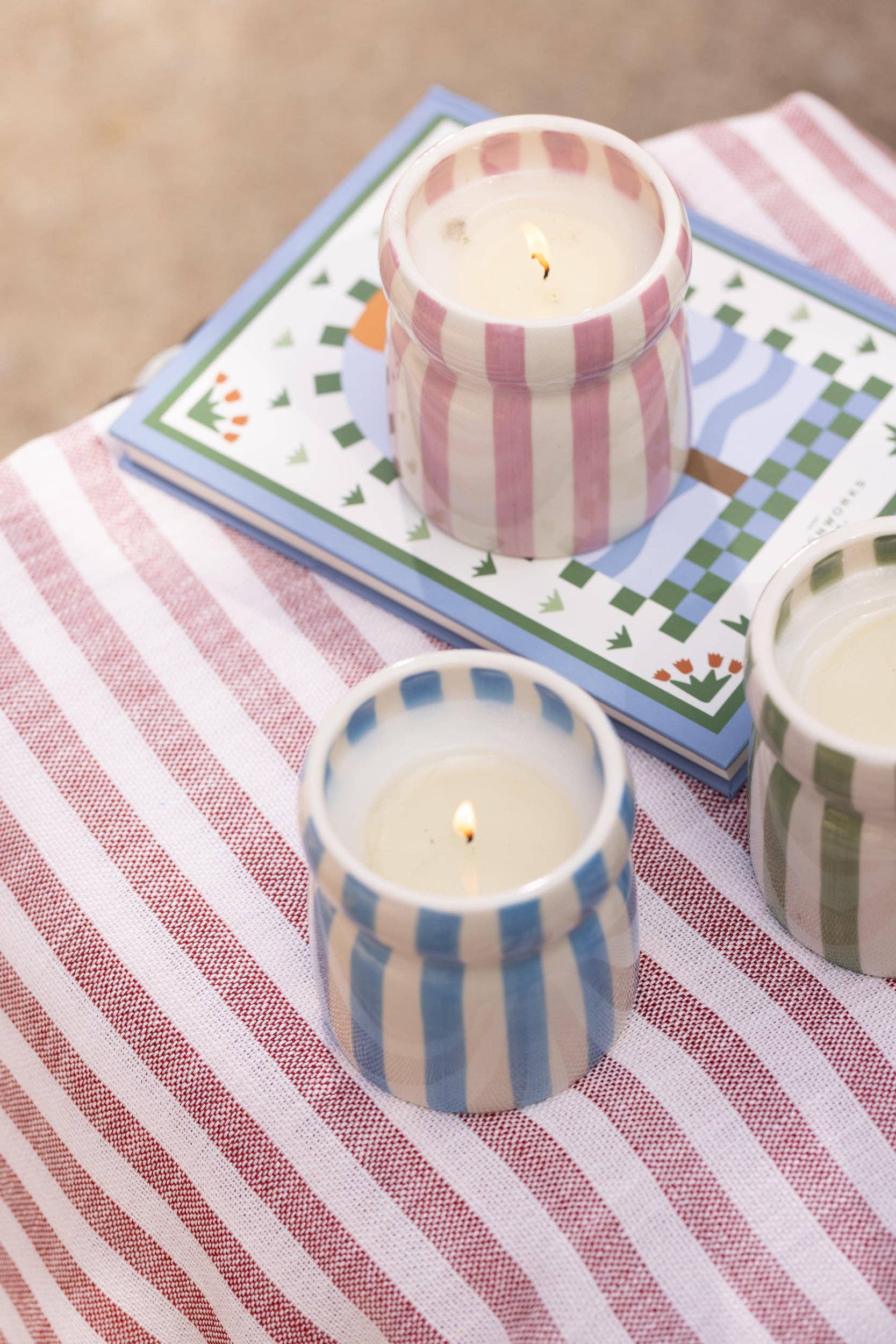 Striped candles on a table with a striped tablecloth