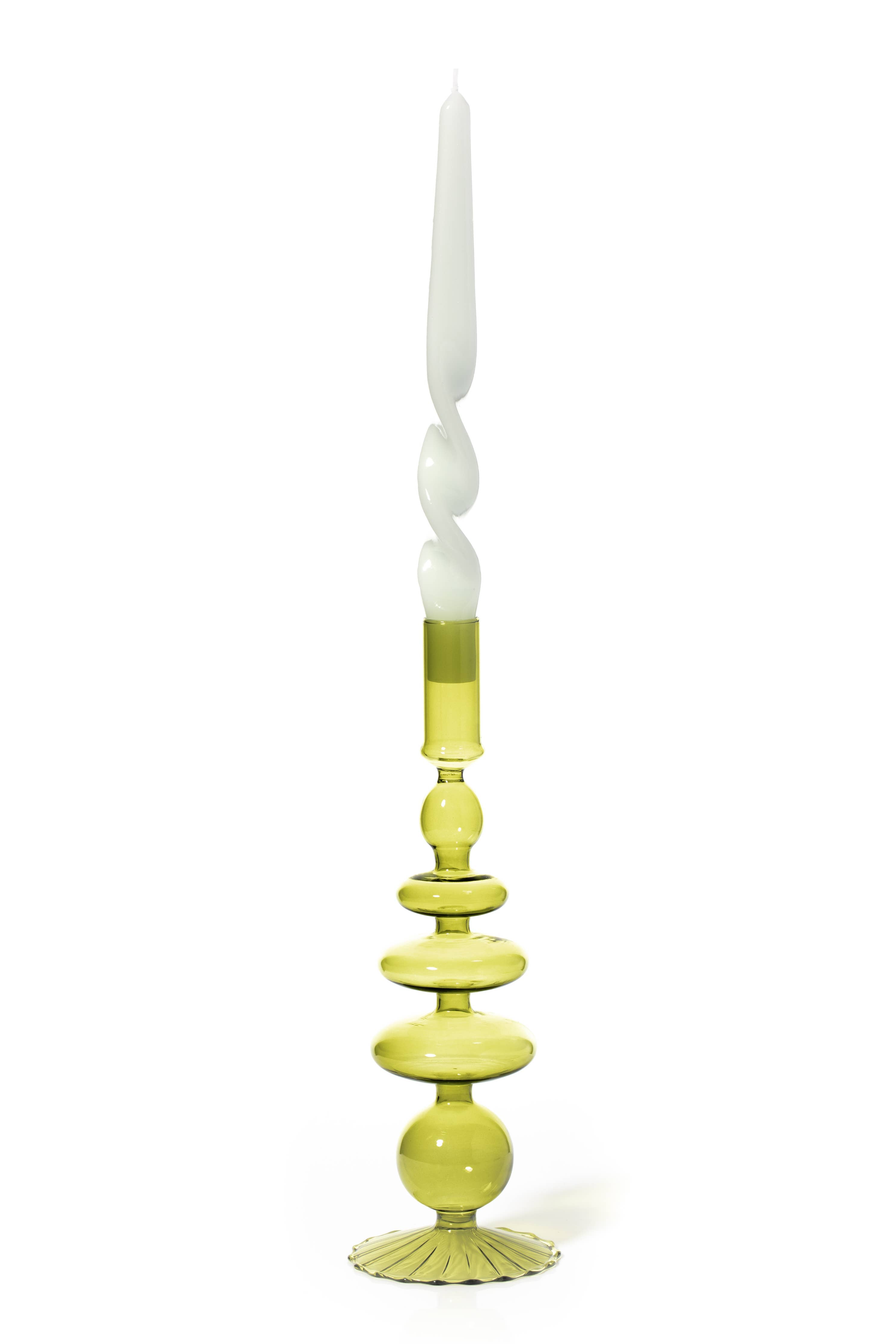 Decorative candle holder with a white candle on a white background