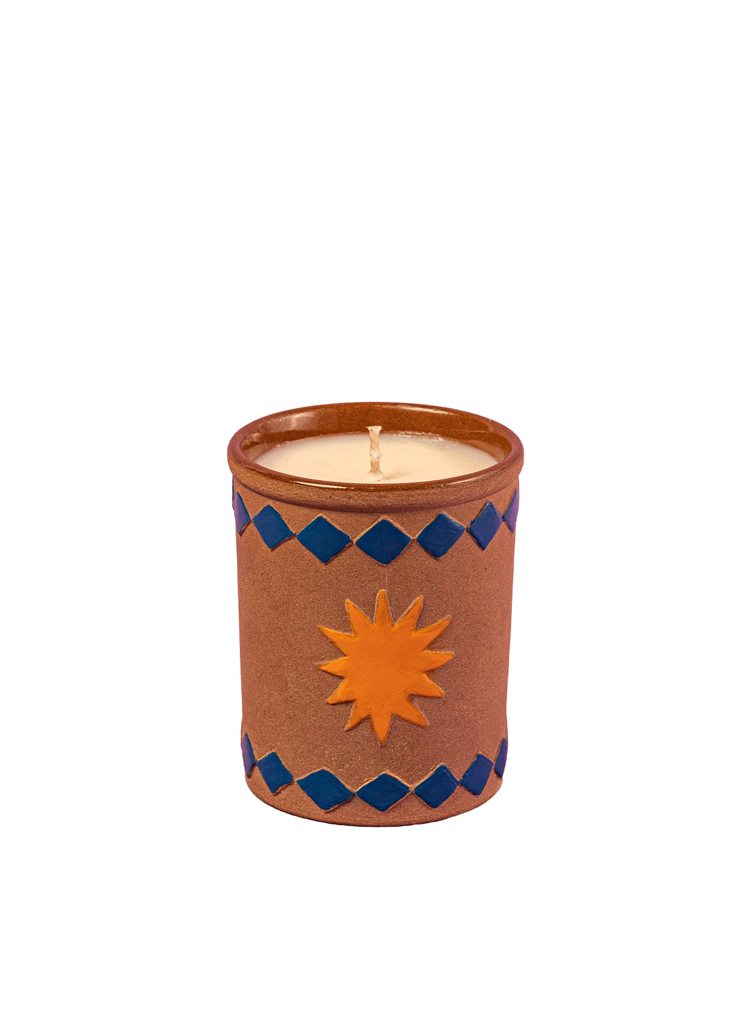 Candle in a decorative terracotta holder with sun design on a white background