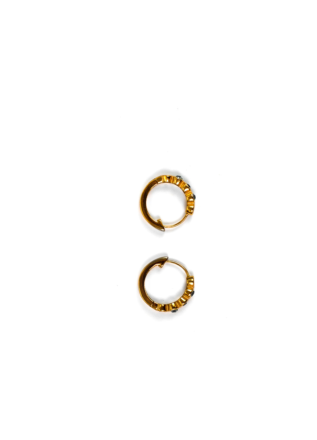 A pair of small gold huggie hoop earrings with textured, beaded edges, displayed vertically on a solid white background. 