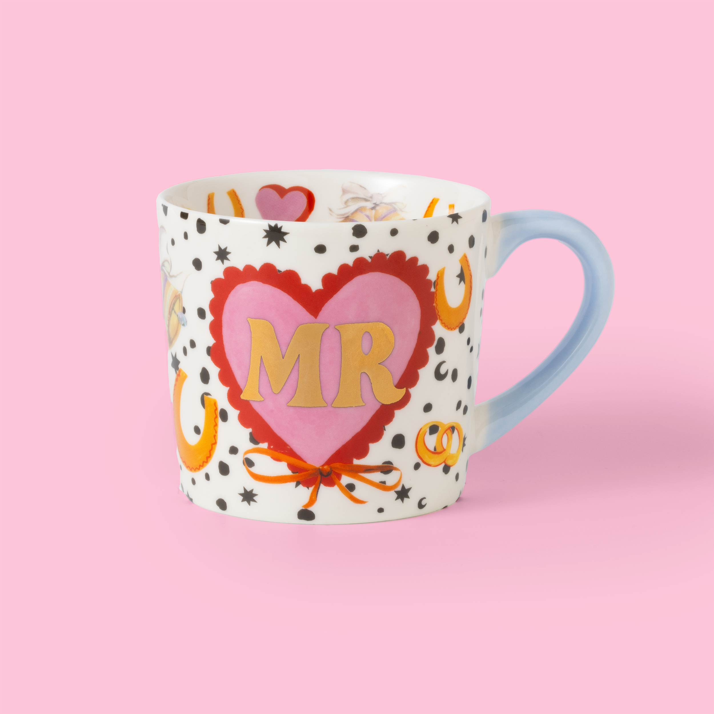 Mug with heart design and 'MR' text on a pink background