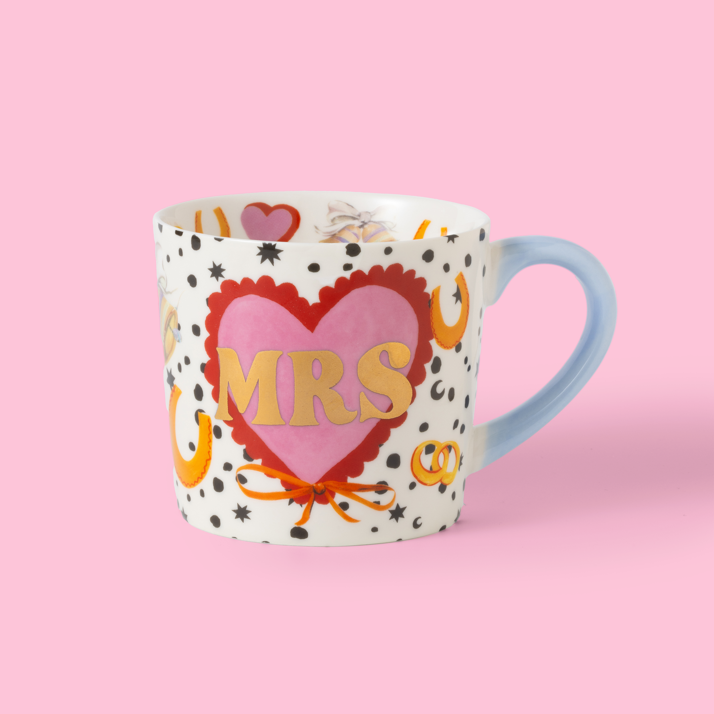 Mug with heart design and 'MRS' text on a pink background