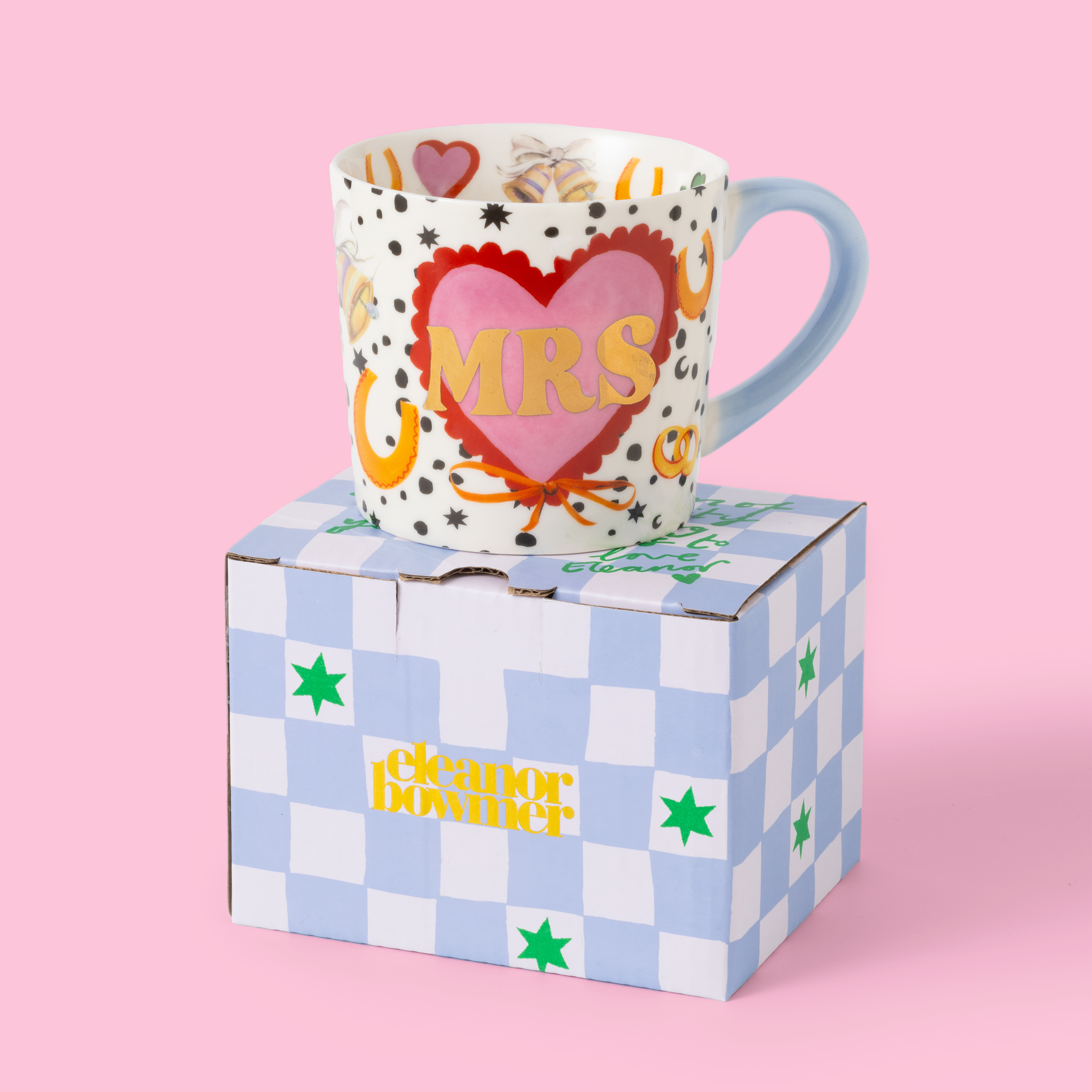 Mug with 'MRS' design on a checkered box against a pink background