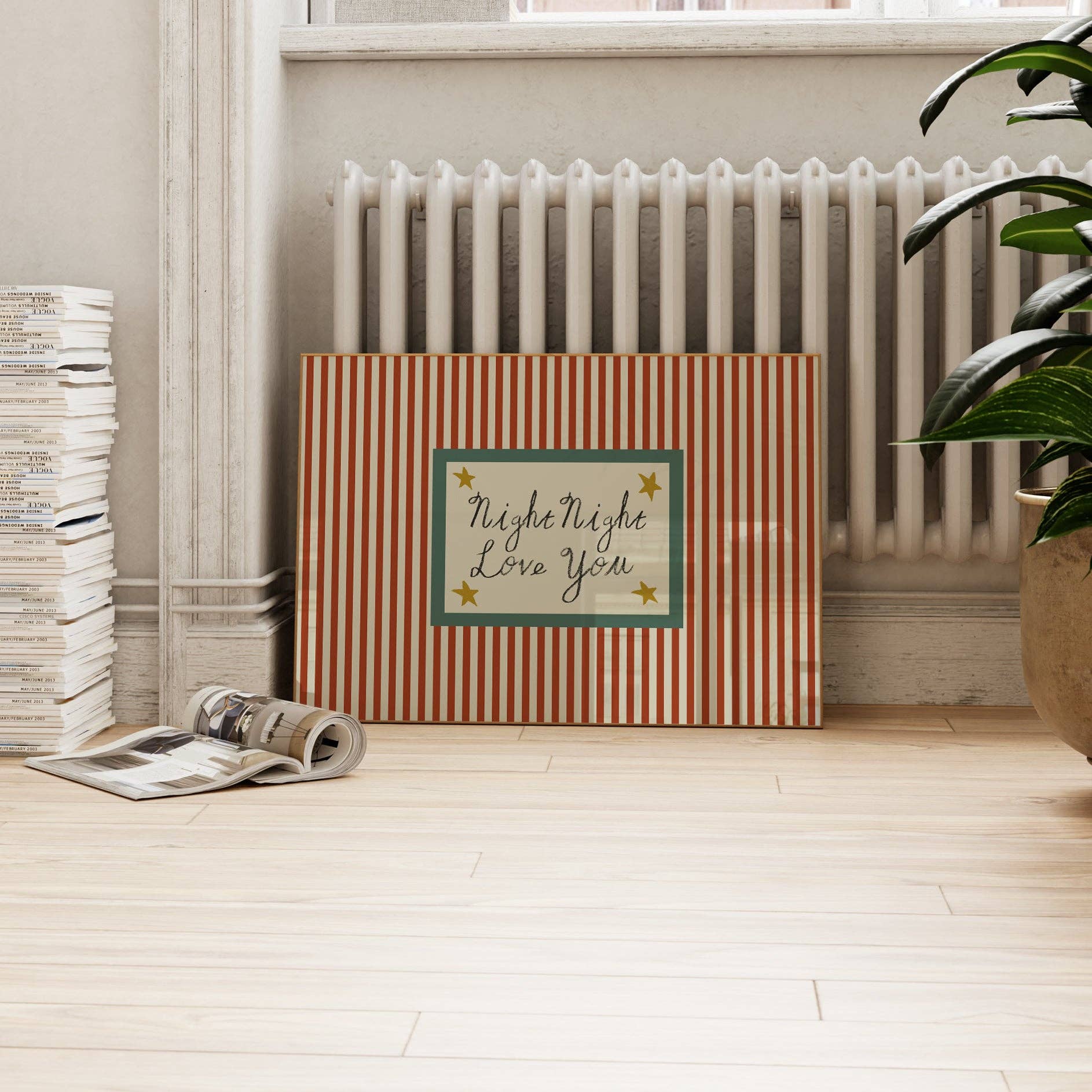 Striped box with 'Night Night Love You' text in a room with a radiator and plant.