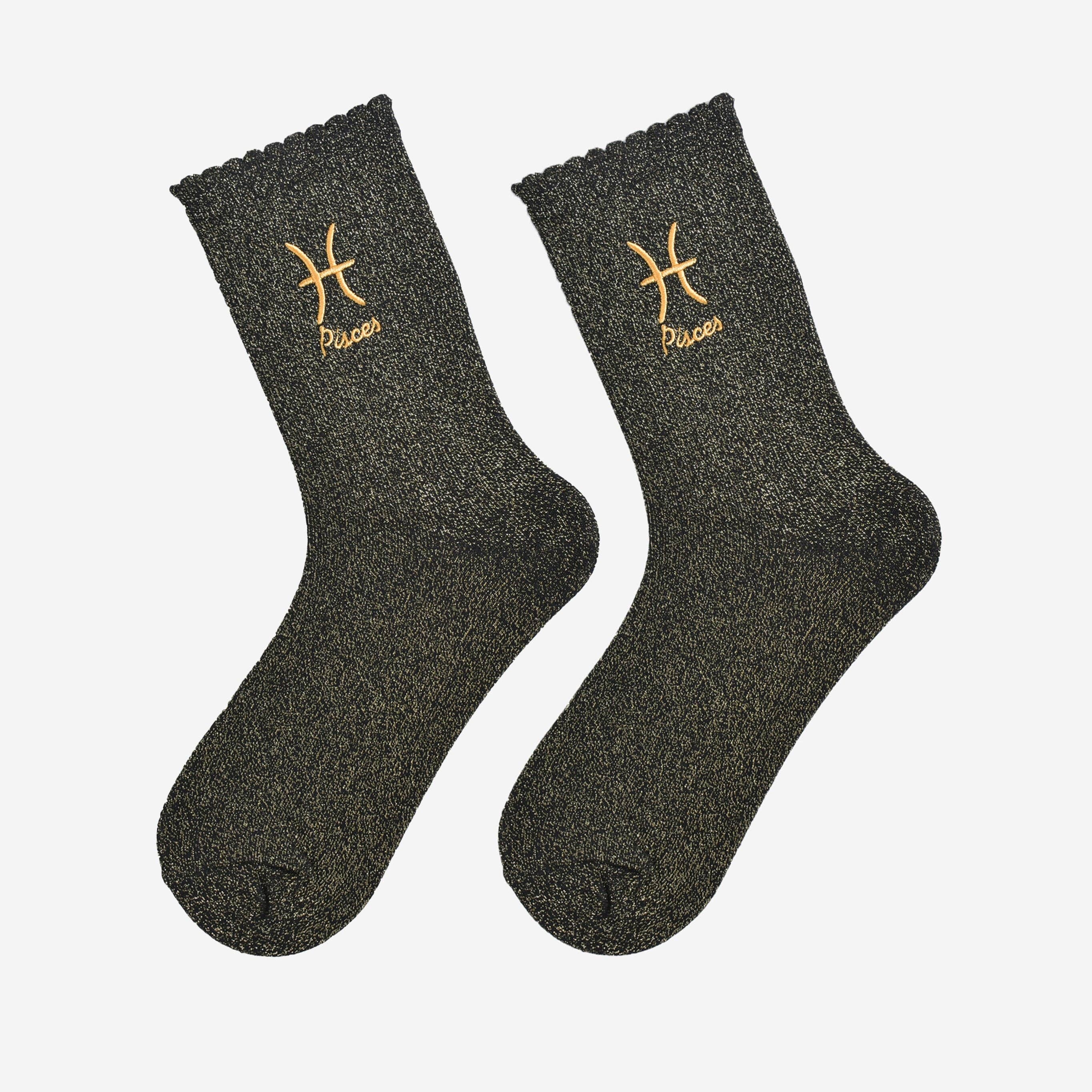Pair of dark gray socks with gold embroidered signs on a white background