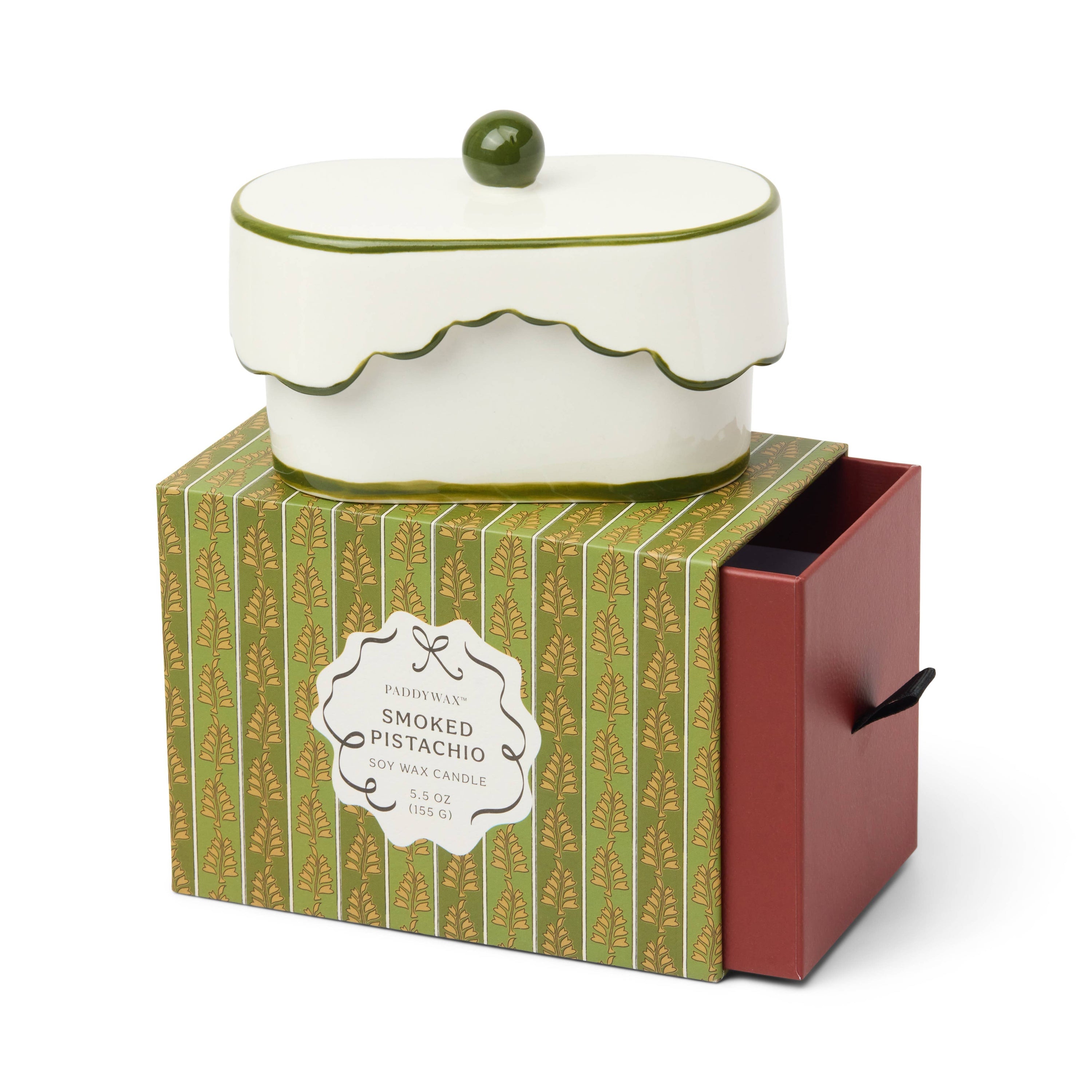 Decorative ceramic candle displayed on its gift box with aa white background