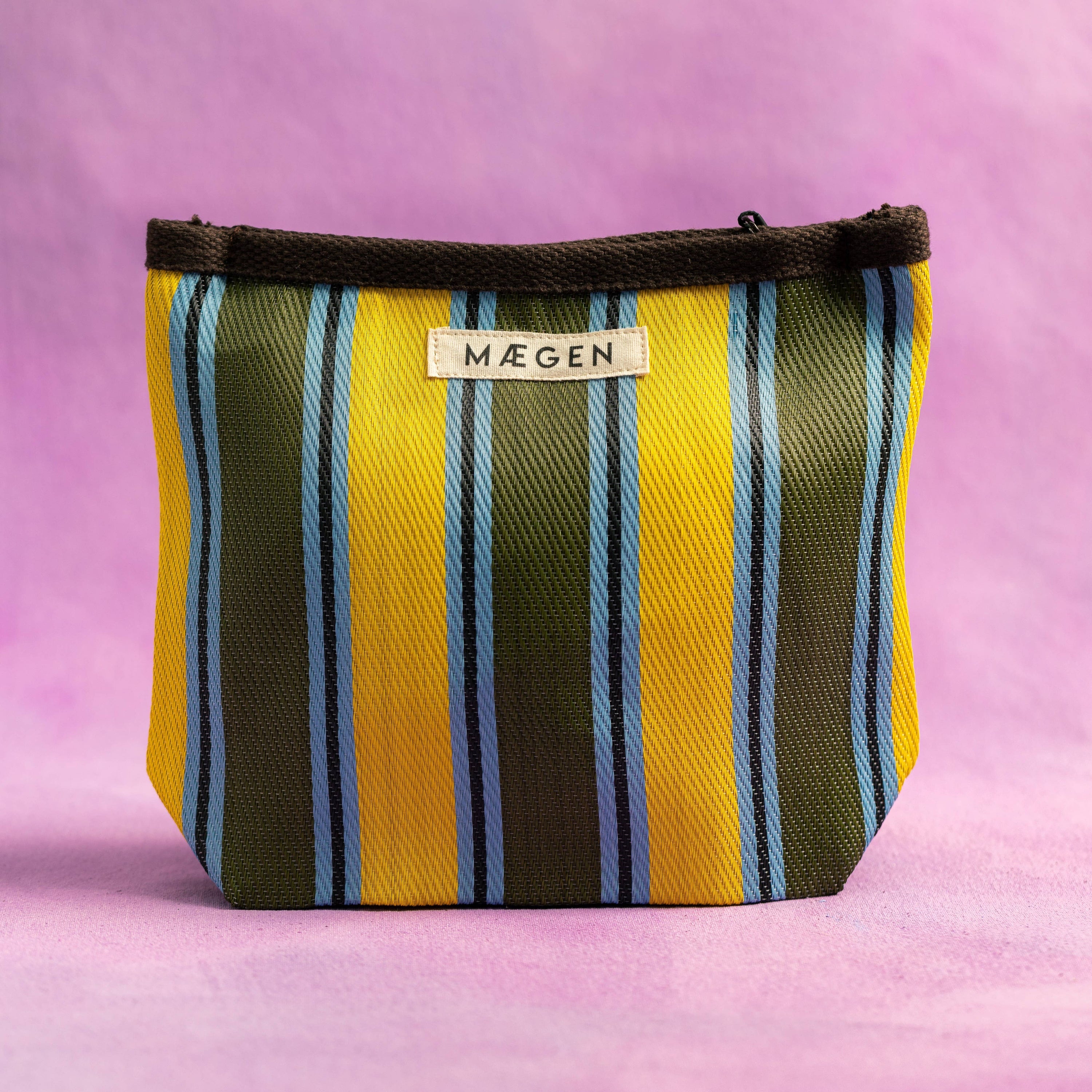 Striped pouch with 'Maegen' brand label on a pink background
