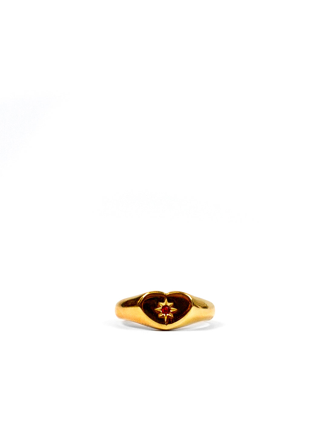 RED HEART GEM GOLD SIGNET RING AGAINST A WHITE BACKGROUND