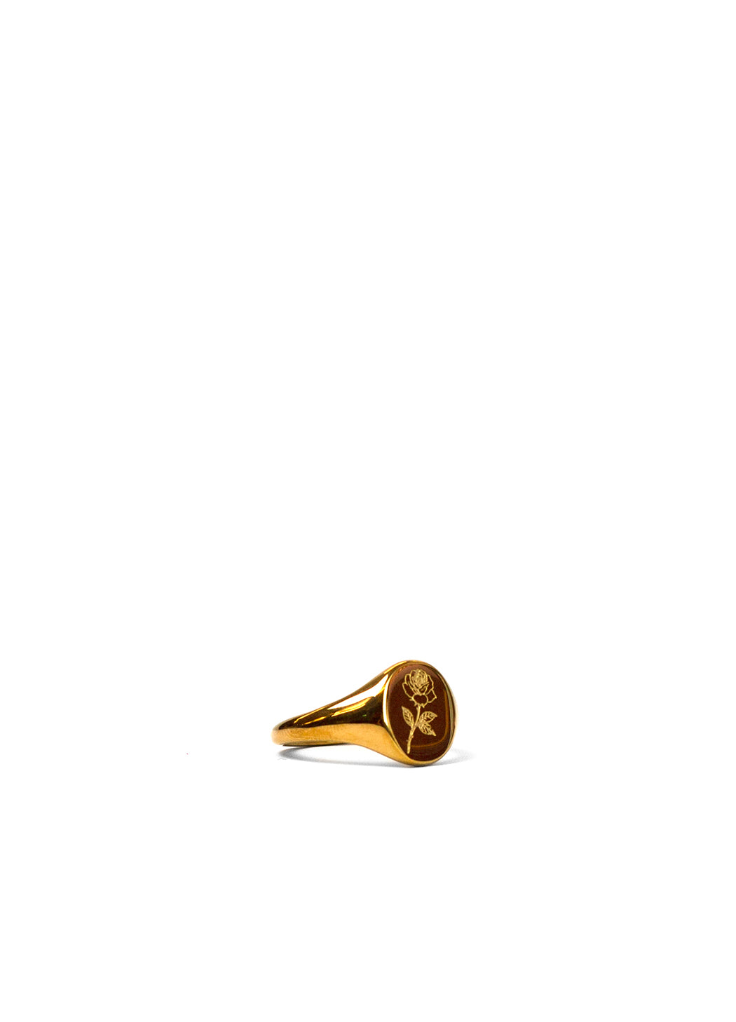 A gold signet ring with a rose engraving on the face, photographed on a seamless white background.