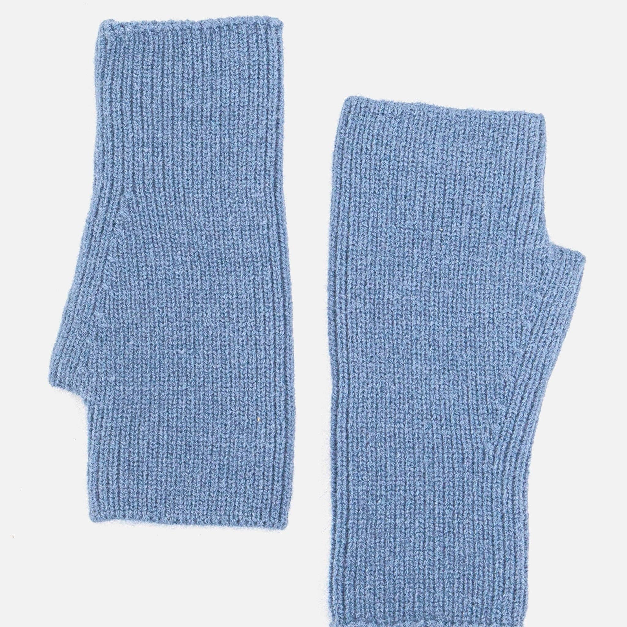 Pair of blue knitted arm warmers on a light gray background