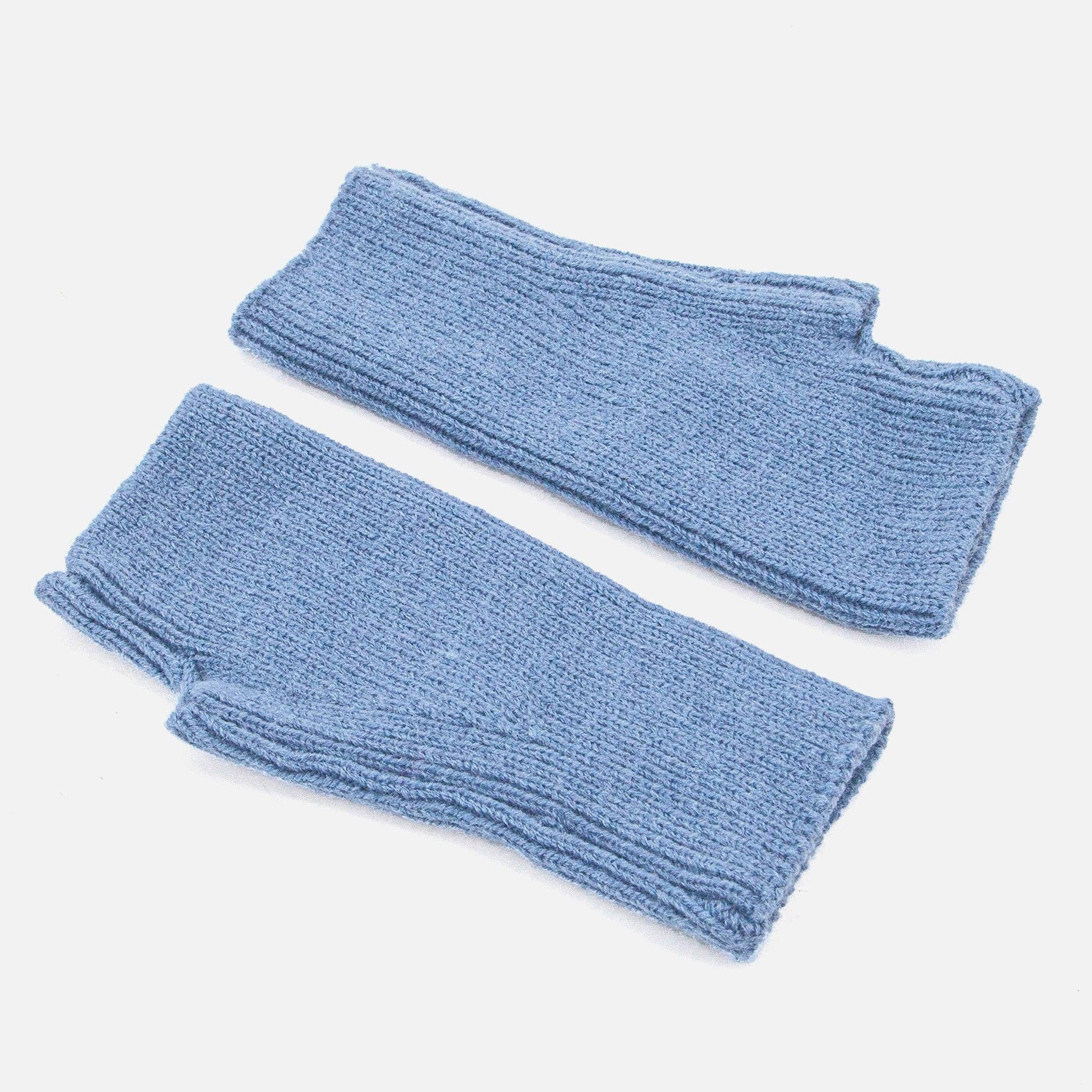 Pair of blue knitted arm warmers on a white background