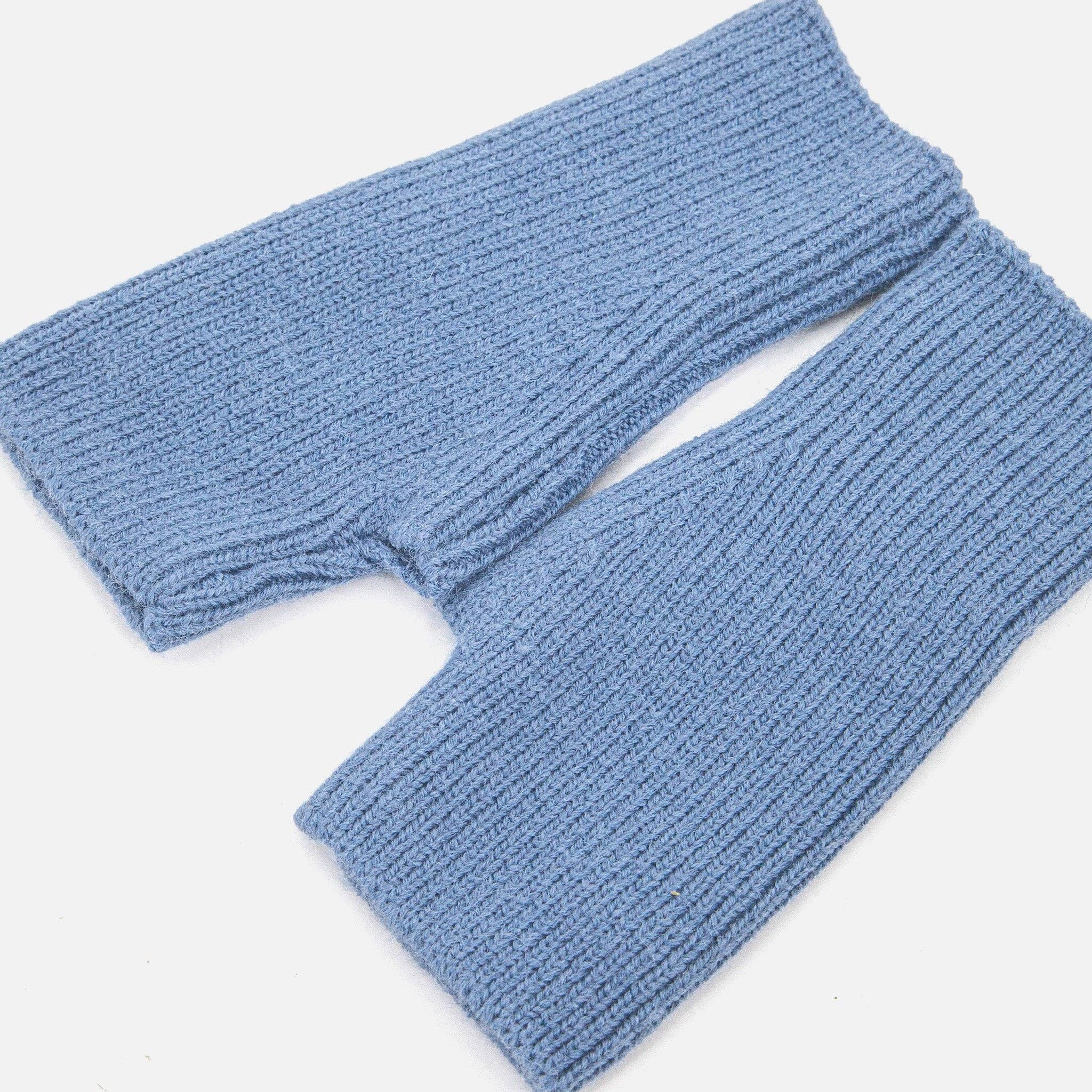 Pair of blue knitted leg warmers on a white background
