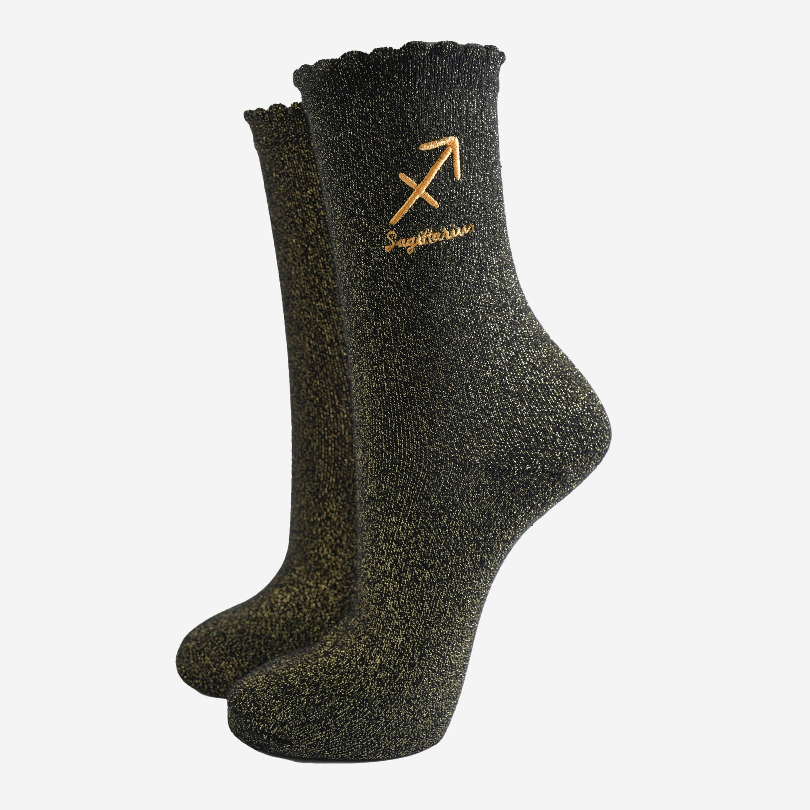 Pair of dark gray socks with a gold embroidered design on a white background