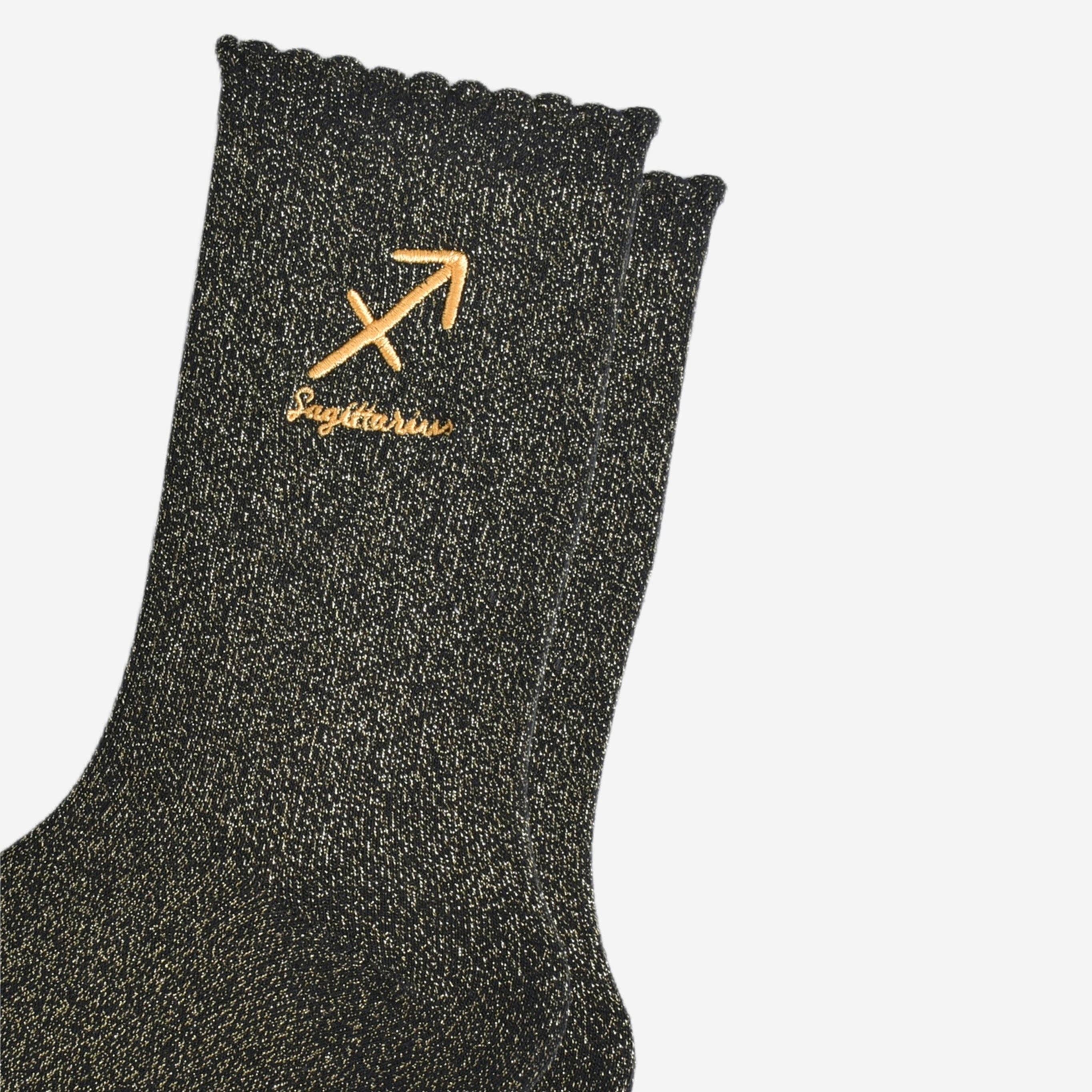 Black sock with gold embroidery on a white background