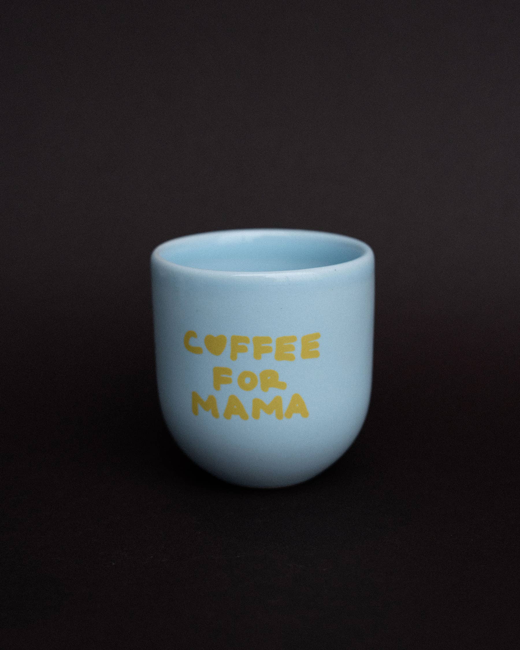 Light blue mug with 'Coffee for Mama' text on a black background