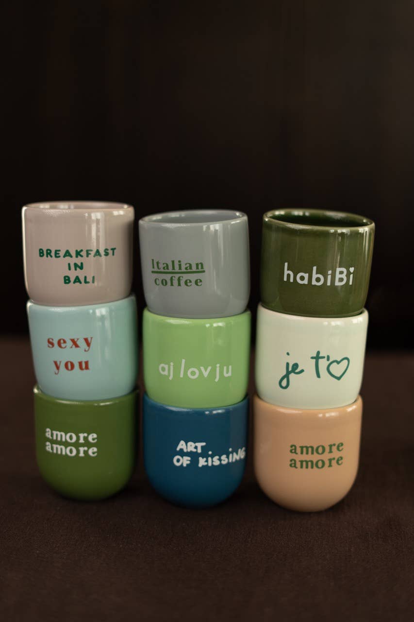 Set of colorful ceramic containers with text on a dark background