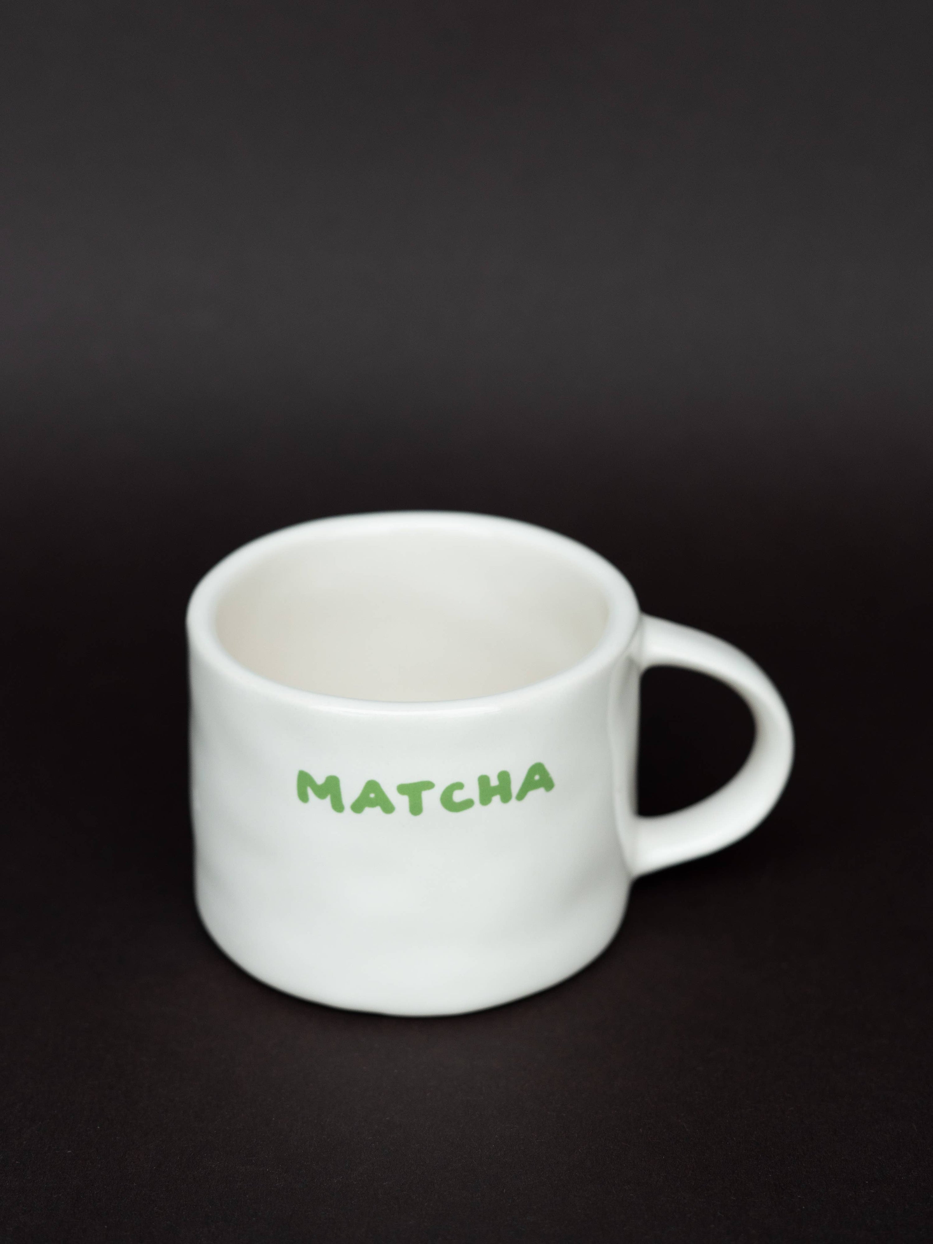 White mug with 'MATCHA' text on a black background