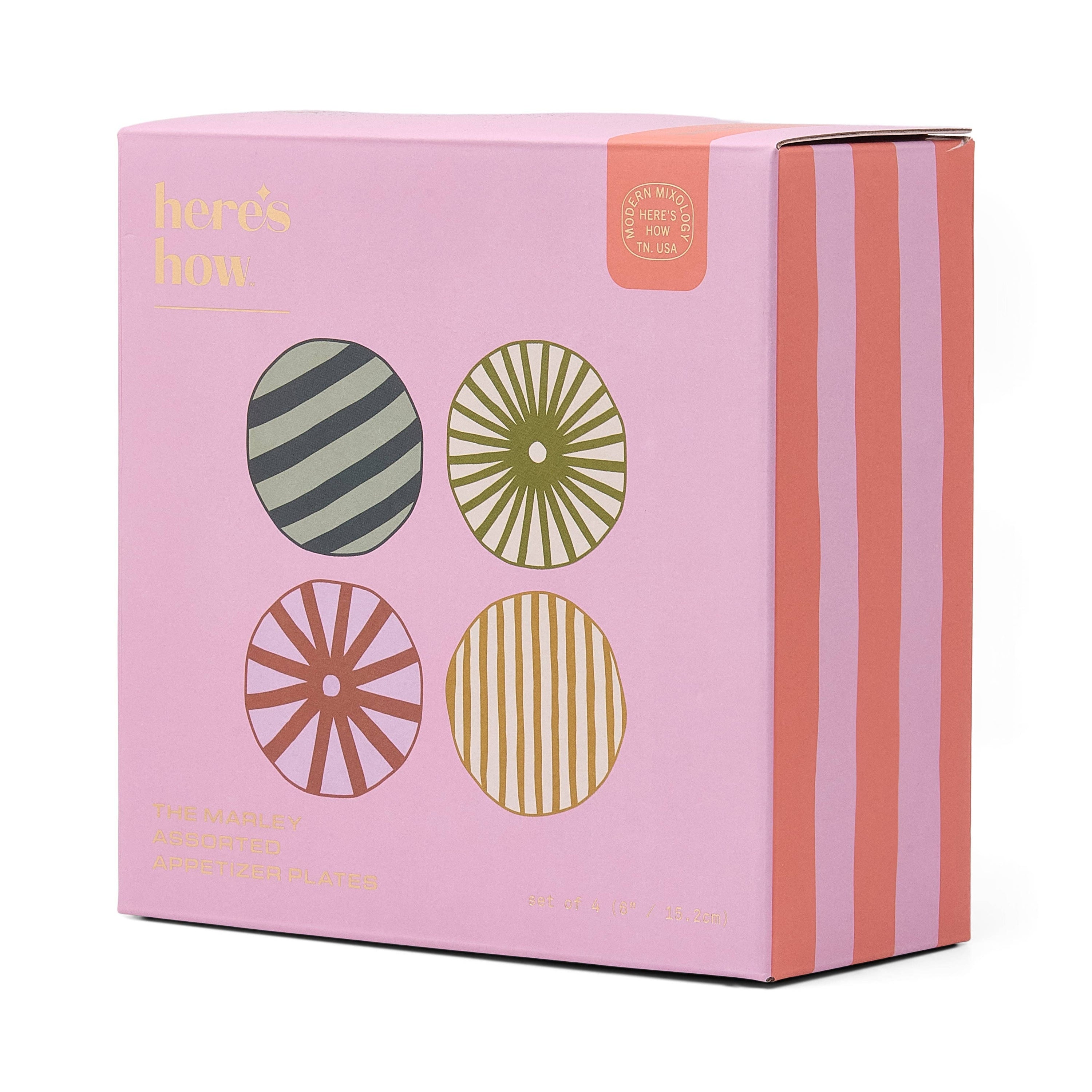 Pink packaging box of the four plates set, with decorative elements on a white background