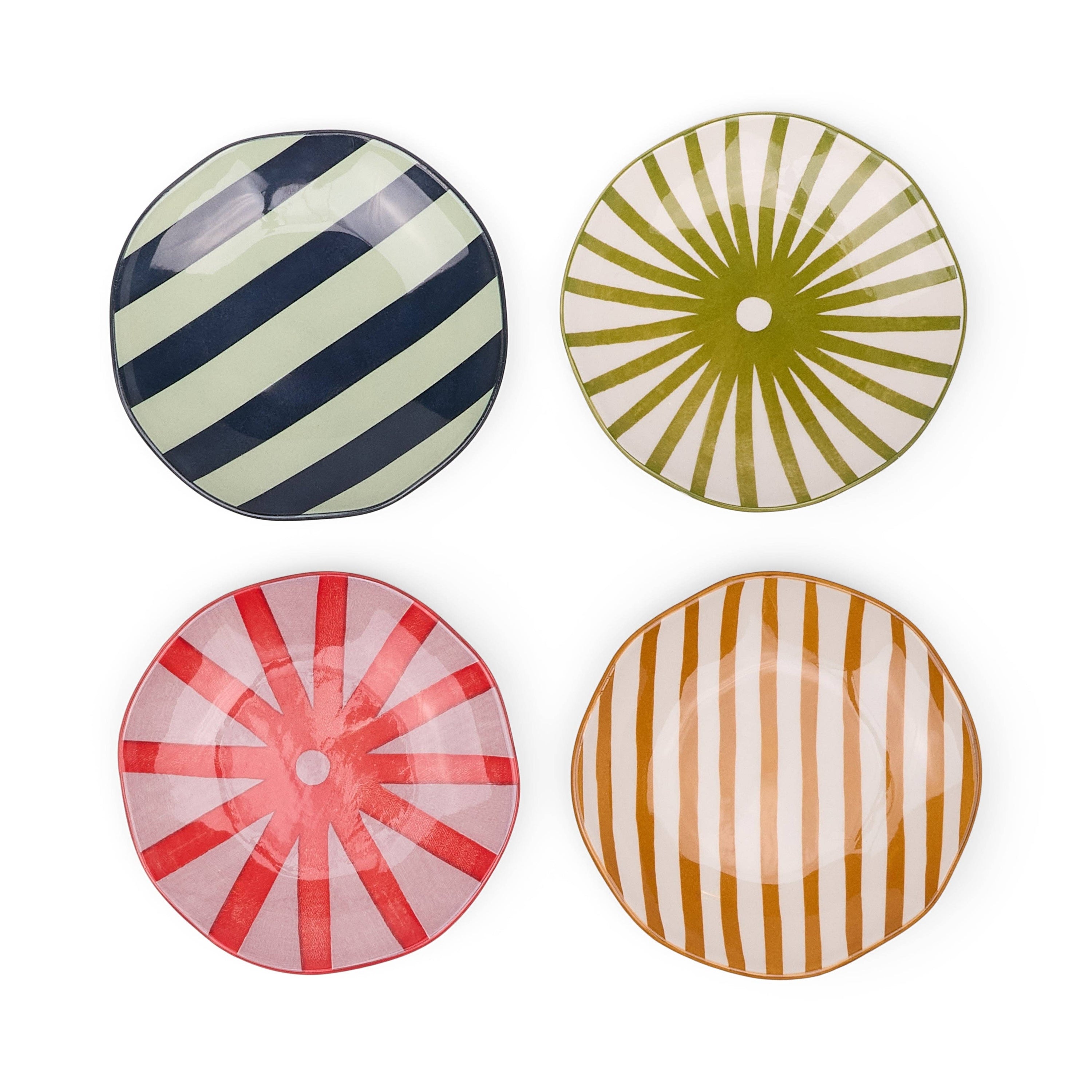 Four colourful ceramic plates with striped patterns on a white background