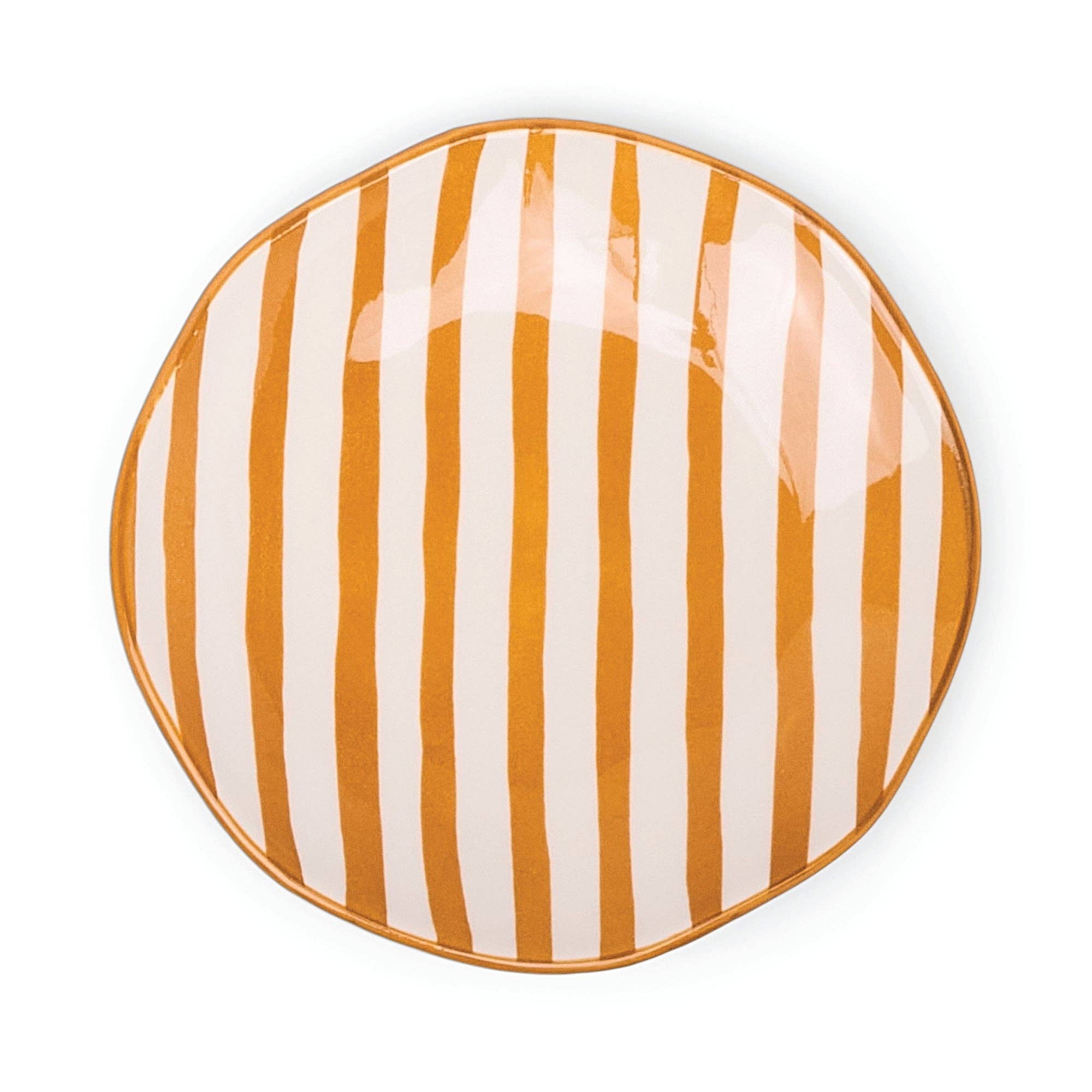Round plate with orange and white vertical stripes on a white background